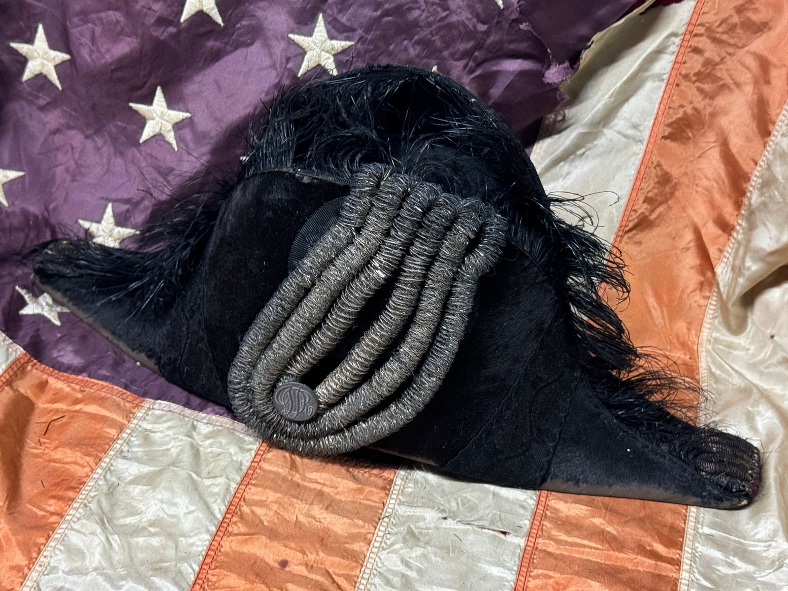 RARE REVOLUTIONARY WAR OFFICER BICORN HAT FROM DELAWARE: RARE REVOLUTIONARY WAR OFFICER BICORN HAT FROM DELAWARE. A VERY SCARCE EXAMPLE THAT IS IN MINT OVERALL SHAPE AND CONDITION WITH A BEAUTIFUL OVERALL PATINA. HAS THE DELAWARE REVOLUTIONARY WAR BUTTON AT