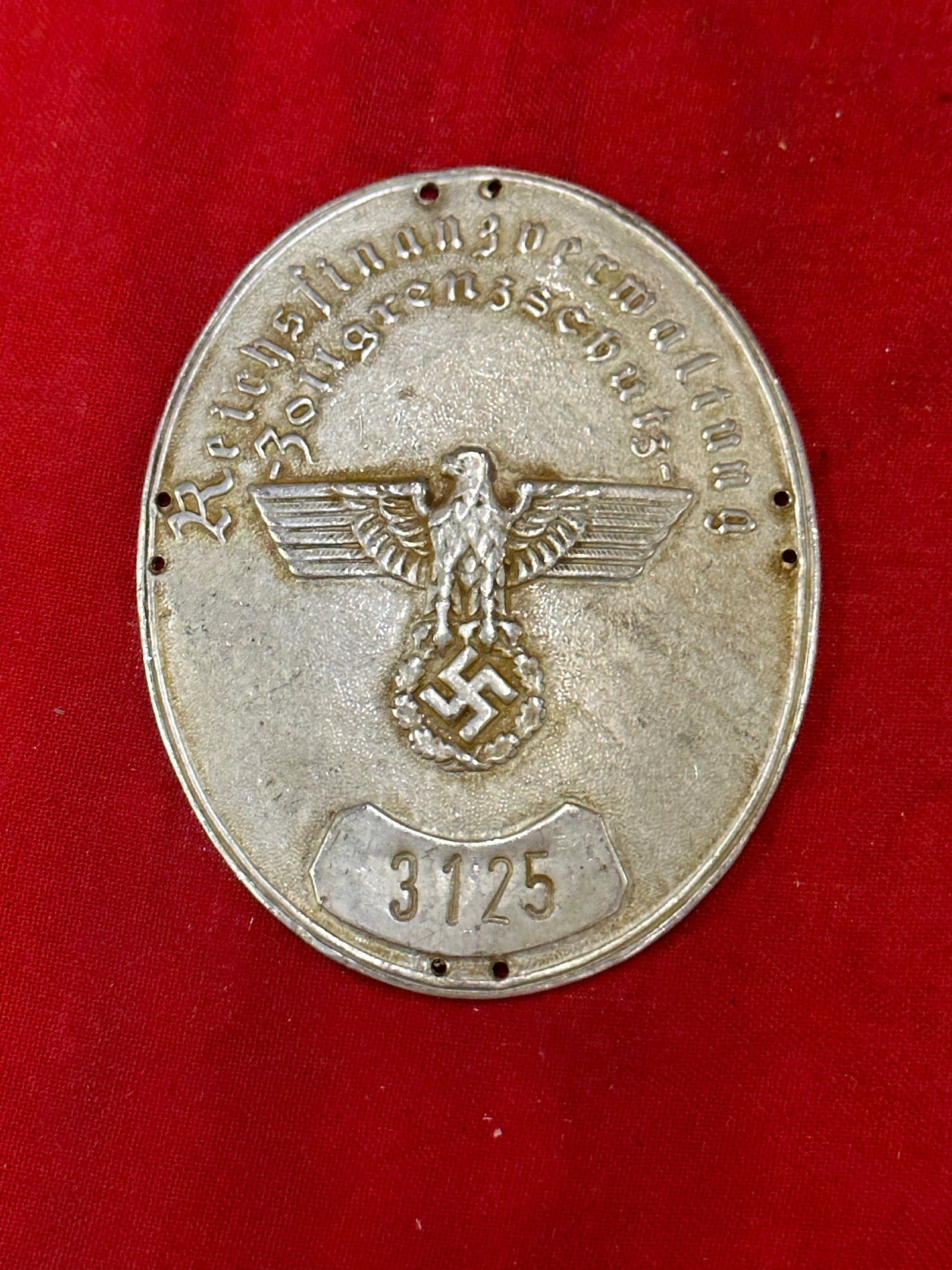 RARE WW2 GERMAN REICH CUSTOMS STAMPED BADGE SHIELD # 3125: RARE WW2 GERMAN REICH CUSTOMS STAMPED BADGE SHIELD # 3125. This stamped badge is oval in shape with a hollow back. It features the details of the Reich customs organization at the top and in the cente