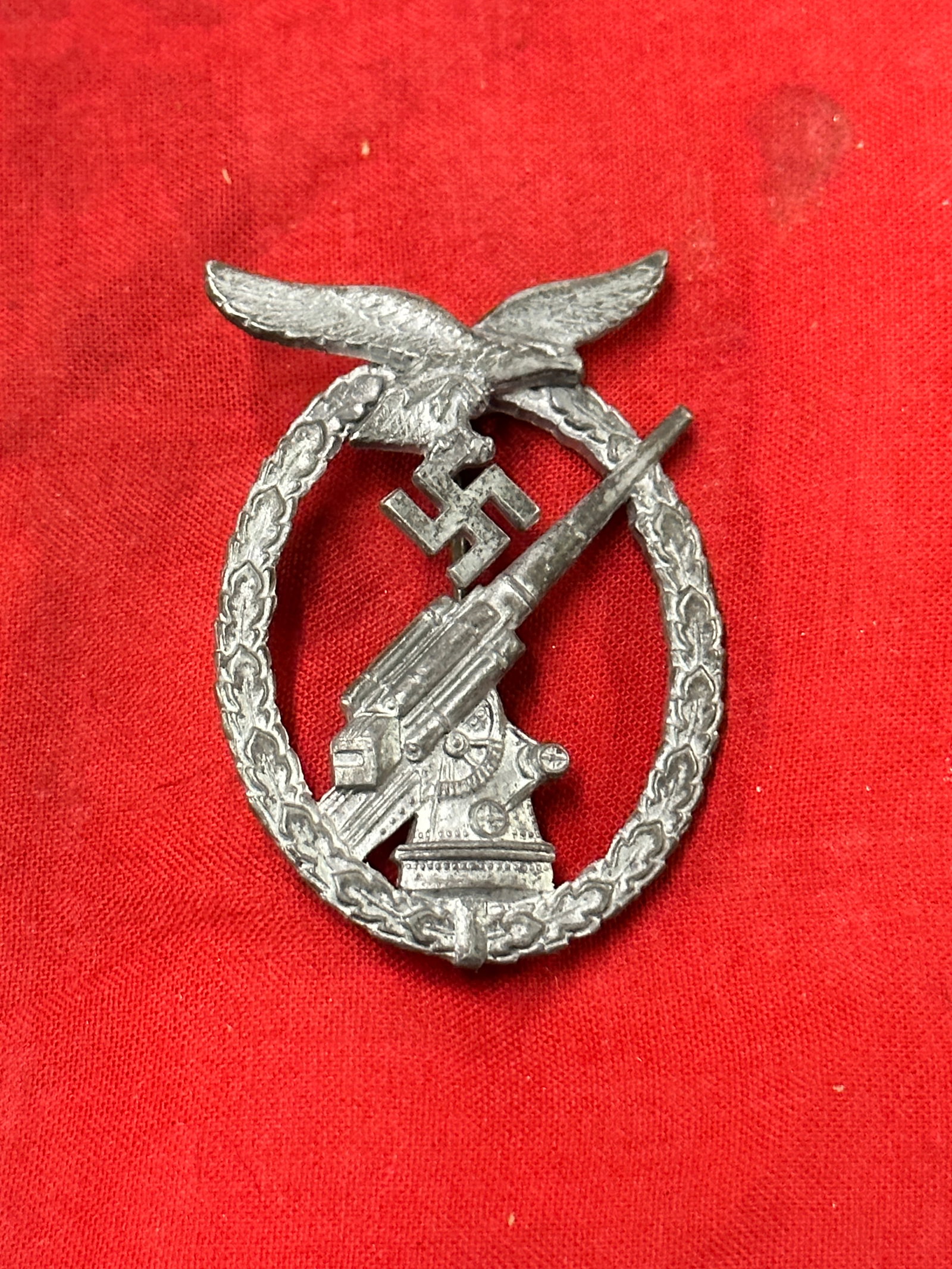 WW2 German Zinc Luftwaffe Flakkampfabzeichen Badge With Maker Marks: WW2 German Zinc Luftwaffe Flakkampfabzeichen Badge With Maker Marks. An ultra rare find that is in mint overall shape and condition with a beautiful overall patina. Shows good wear and use. Please vei