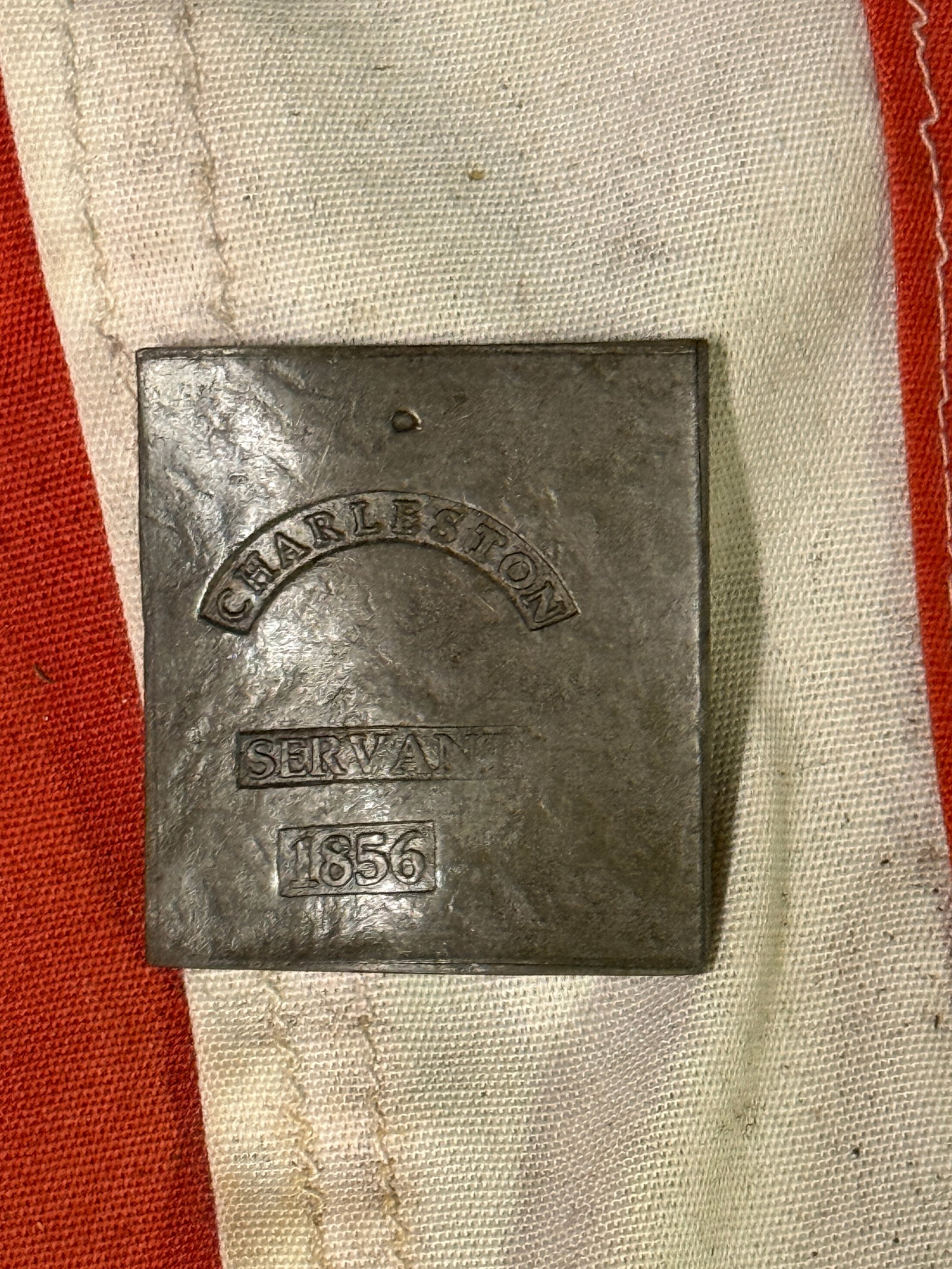 DATED 1856 CHARLESTON SERVANT ID SLAVE TAG: DATED 1856 CHARLESTON SERVANT ID SLAVE TAG. AN ULTRA RARE FIND THAT IS IN MINT OVERALL SHAPE AND CONDITION WITH A BEAUTIFUL OVERALL PATINA. SHOWS GOOD WEAR AND USE. PLEASE VIEW ALL DETAILED PICTURES. 