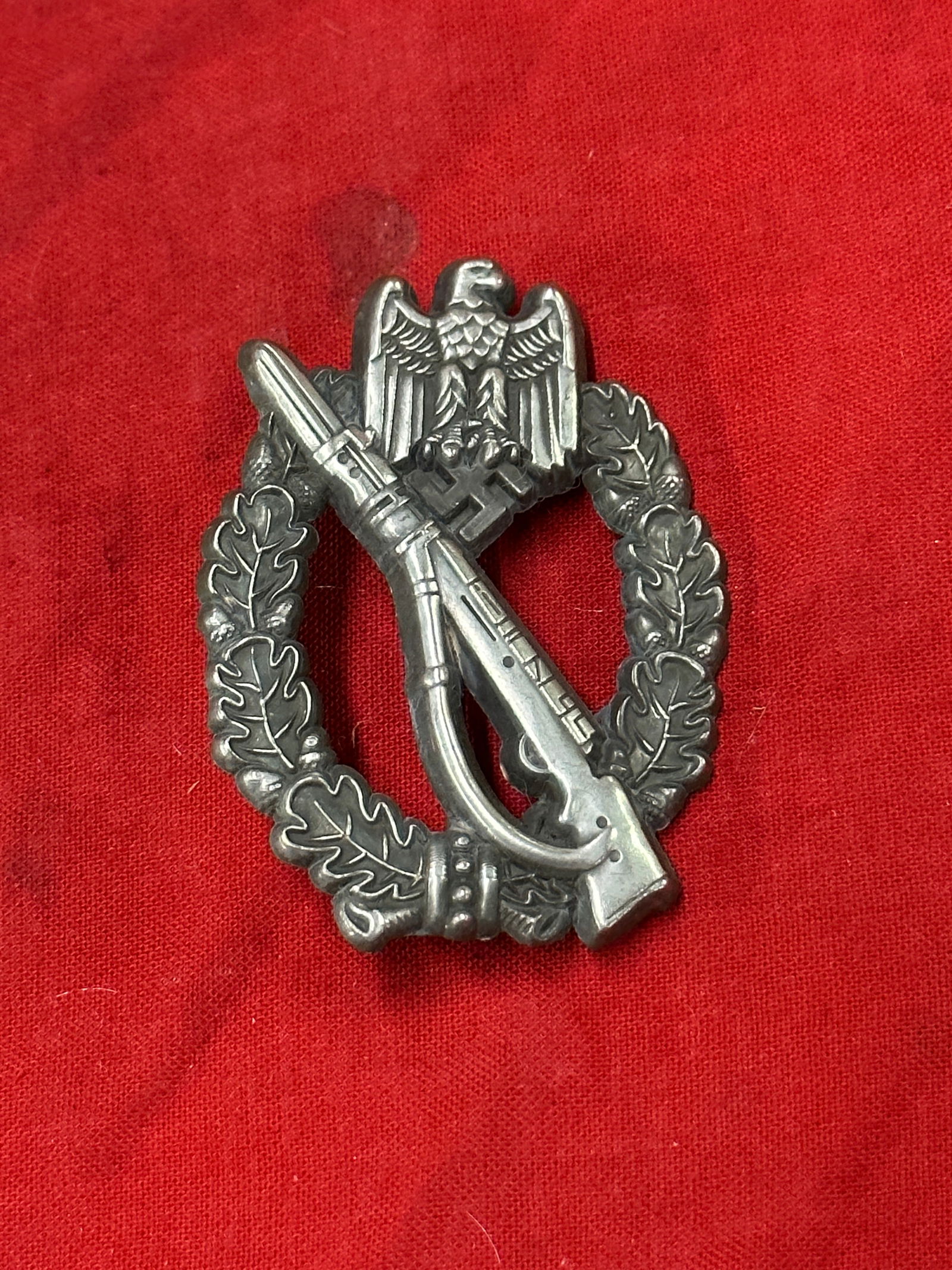 WW2 German Infantry assault badge in silver by H. Wernstein: Infantry assault badge in silver by Hermann Wernstein, Jena. Zink construction with soldered on set up. Unmarked. Interesting example with (period?) replacement hinge. Typical cut-into-shape hinge tha