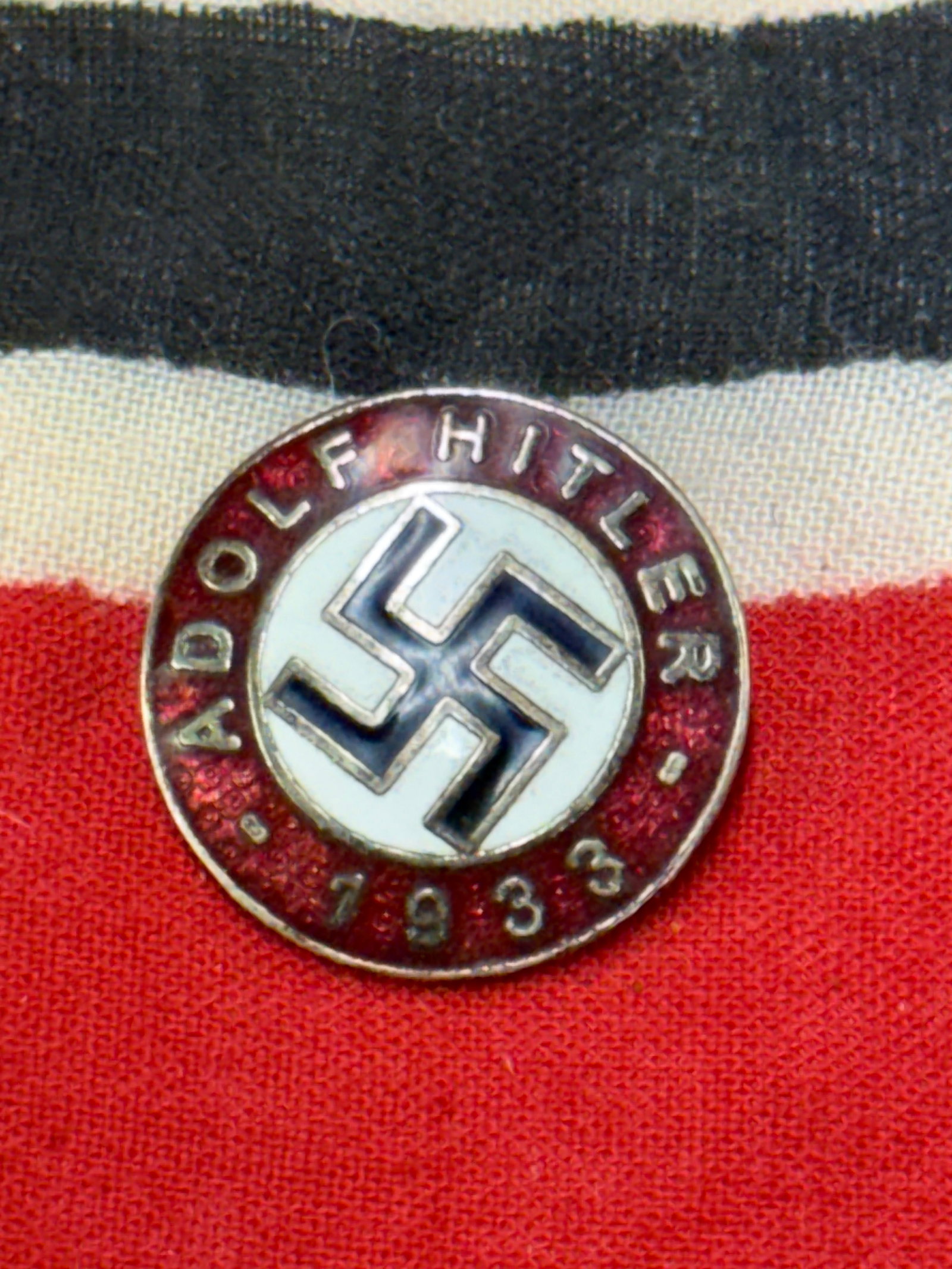 WW2 GERMAN ADOLF HITLER 1933 LAPEL ENAMELED PIN BADGE BY RZM M1/129: WW2 GERMAN ADOLF HITLER 1933 LAPEL ENAMELED PIN BADGE BY RZM M1/129. A SCARCE FIND. SHOWS GOOD WEAR AND USE WITH A BEAUTIFUL OVERALL PATINA. APPEARS TO BE WELL WORN. A RARE EXAMPLE.