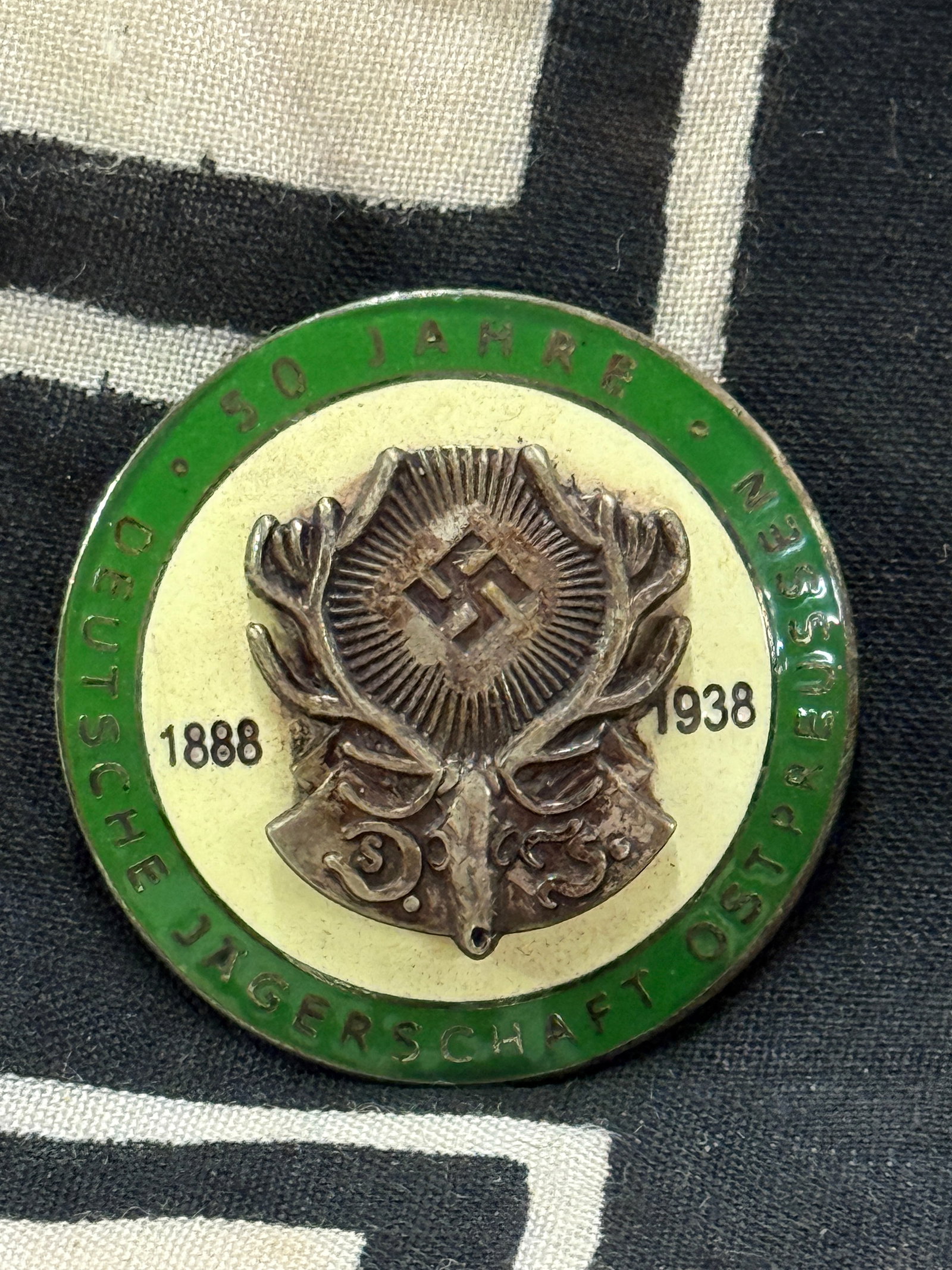 WW2 Geran 1938 Deutsche Jagerschaft 50 Year Members Enameled Badge: WW2 Geran 1938 Deutsche Jagerschaft 50 Year Members Enameled Badge. A scarce find. Shows good wear and use with a beautiful overall patina. Please view all detailed pictures. A scarce example.