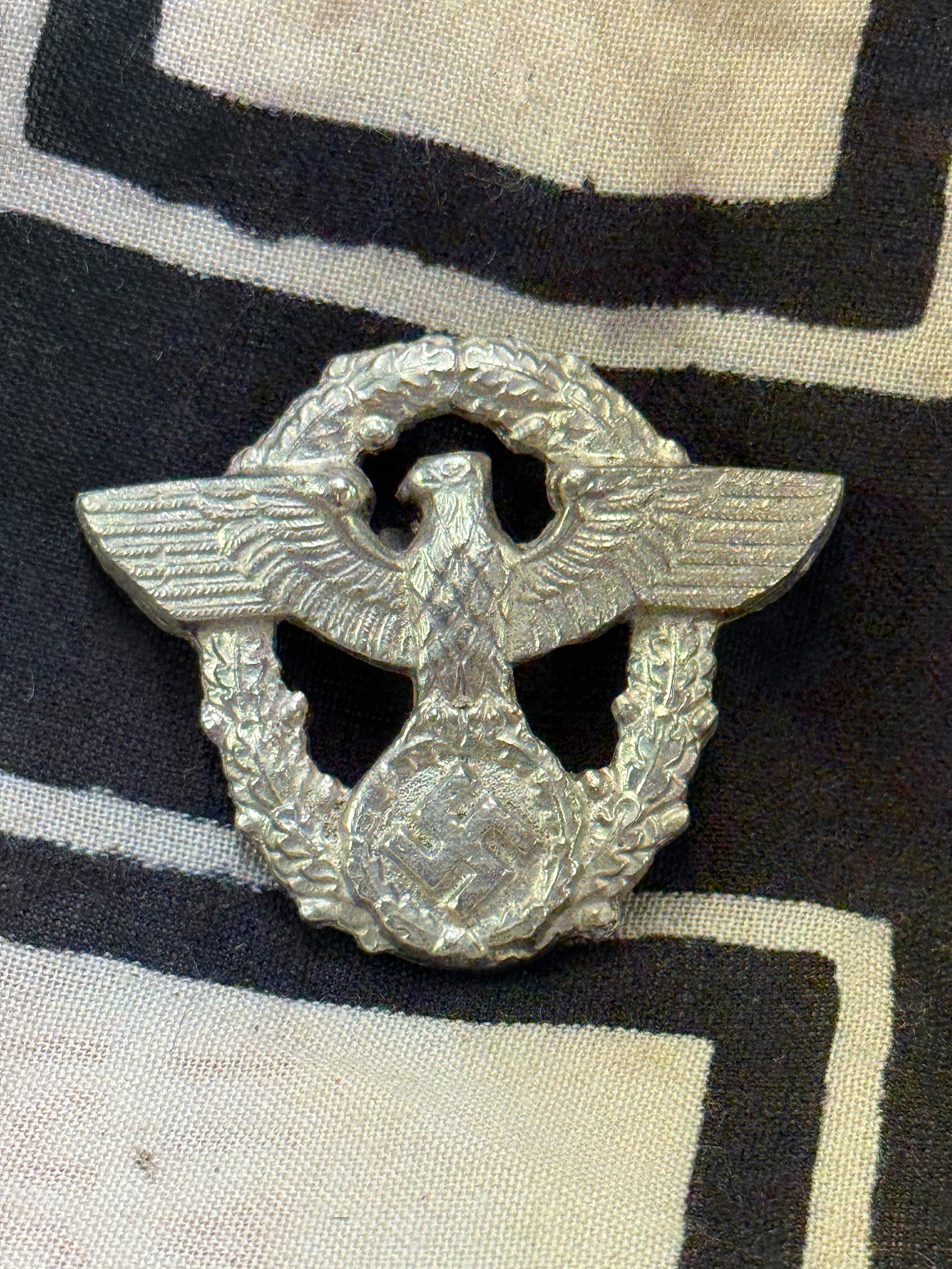 German WWII Police Officer’s Aluminum Cap Badge In Silver: German WWII Police Officer’s Aluminum Cap Badge In Silver. A very scarce example that is in mint overall shape and condition with a beautiful overall patina. A rare find.