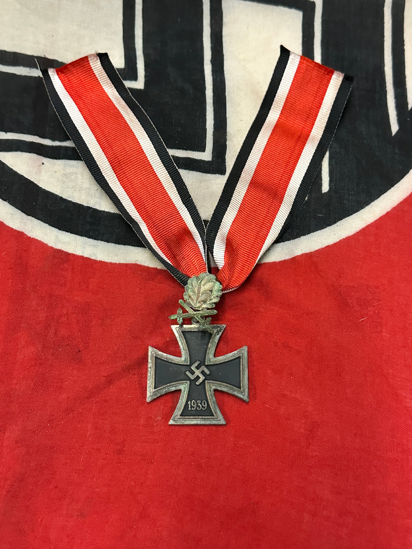 WW2 Iron Cross with Oak Leaves and Swords,included Ribbon: WW2 Iron Cross with Oak Leaves and Swords,included Ribbon. A scarce find. Shows good wear and use with a beautiful overall patina. Please view all detailed pictures. Comes complete with the ribbonand 