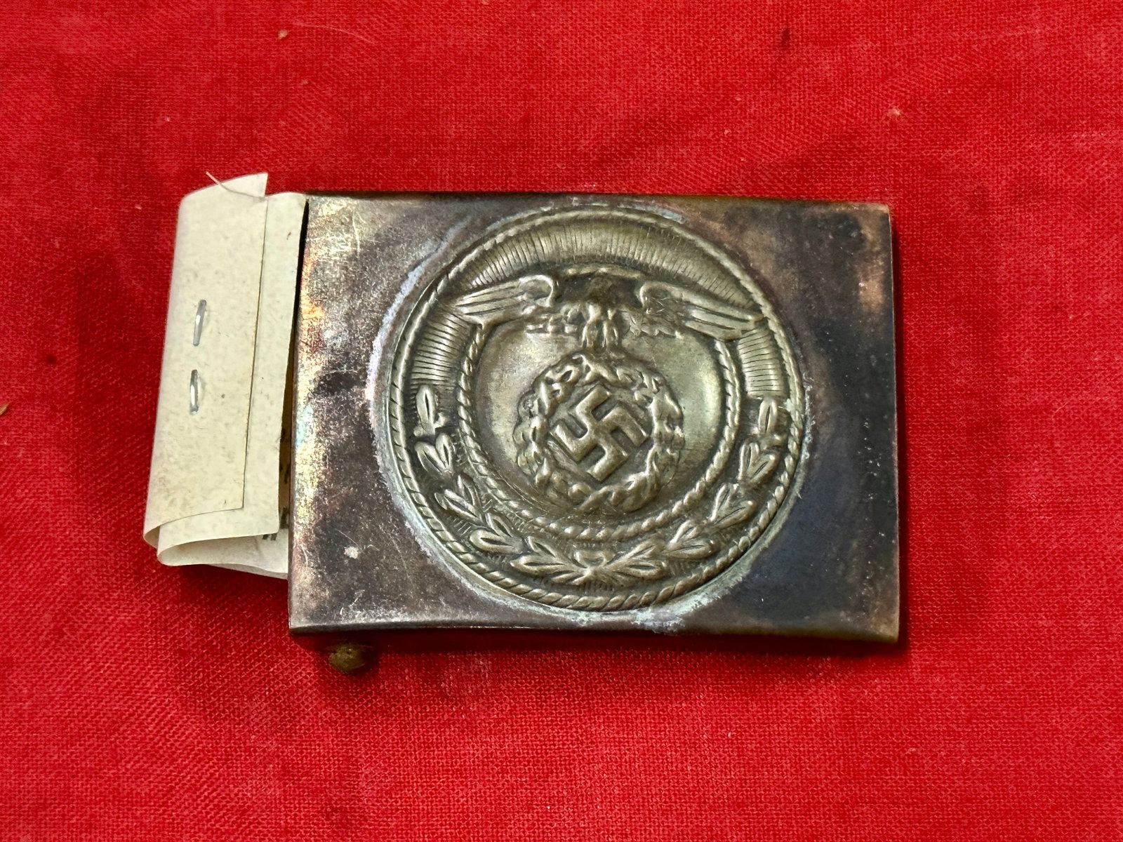 WW2 GERMAN SA OFFICER BELT BUCKLE WITH ORIG. MAKER MARK TAG: WW2 GERMAN SA OFFICER BELT BUCKLE WITH ORIG. MAKER MARK TAG. A RARE FIND. SHOWS GOOD WEAR AND USE WITH A BEAUTIFUL OVERALL PATINA. PLEASE VIEW ALL DETAILED PICTURES. A VERY SCARCE EXAMPLE.