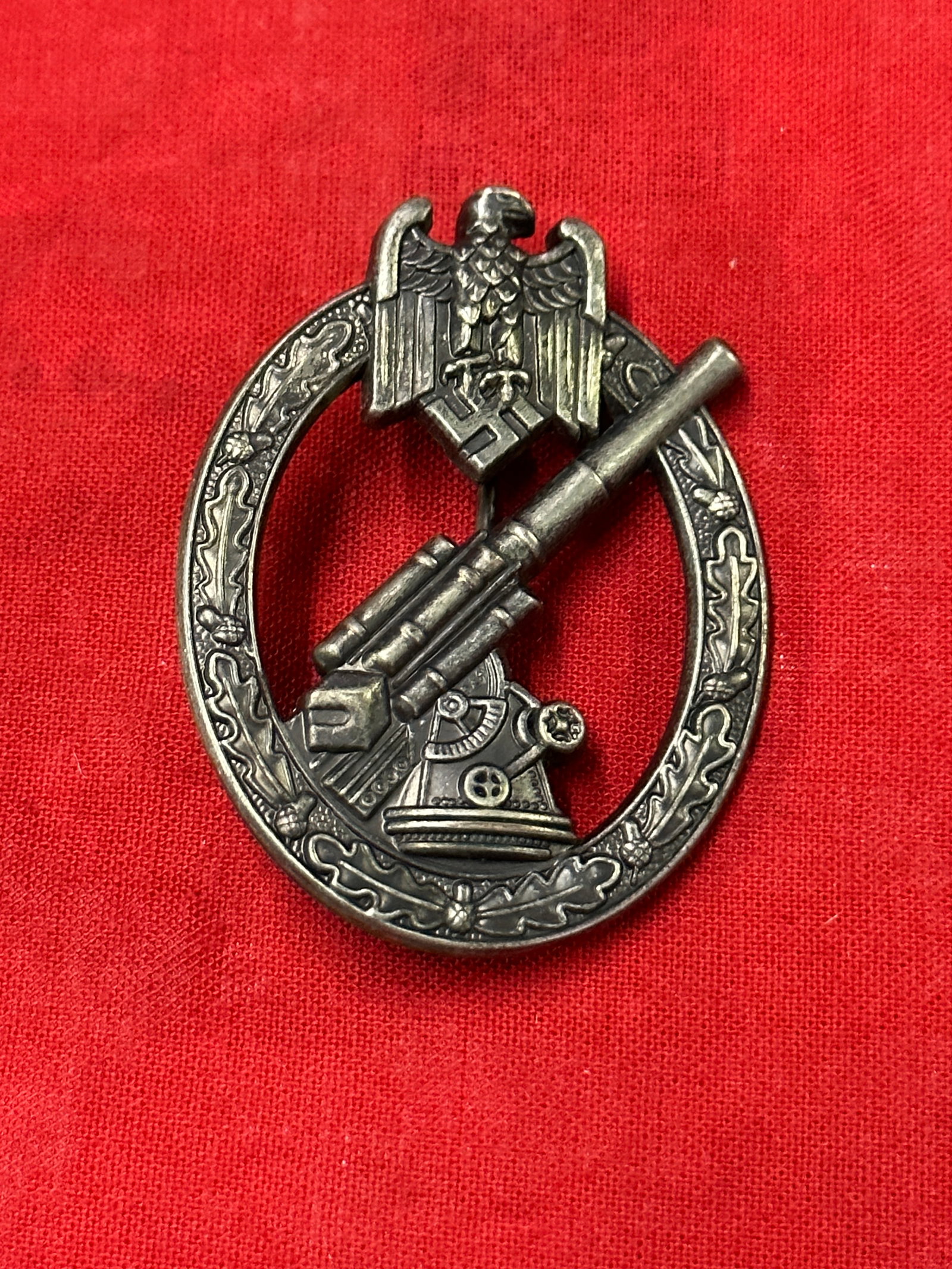 WW2 GERMAN HEER FLAK ARTILLERY BADGE BY W.H. WEIN: WW2 GERMAN HEER FLAK ARTILLERY BADGE BY W.H. WEIN. A RARE FIND. SHOWS GOOD WEAR AND USE WITH A BEAUTIFUL OVERALL PATINA. PLEASE VIEW ALL DETAILED PICTURES. A VERY RARE EXAMPLE.