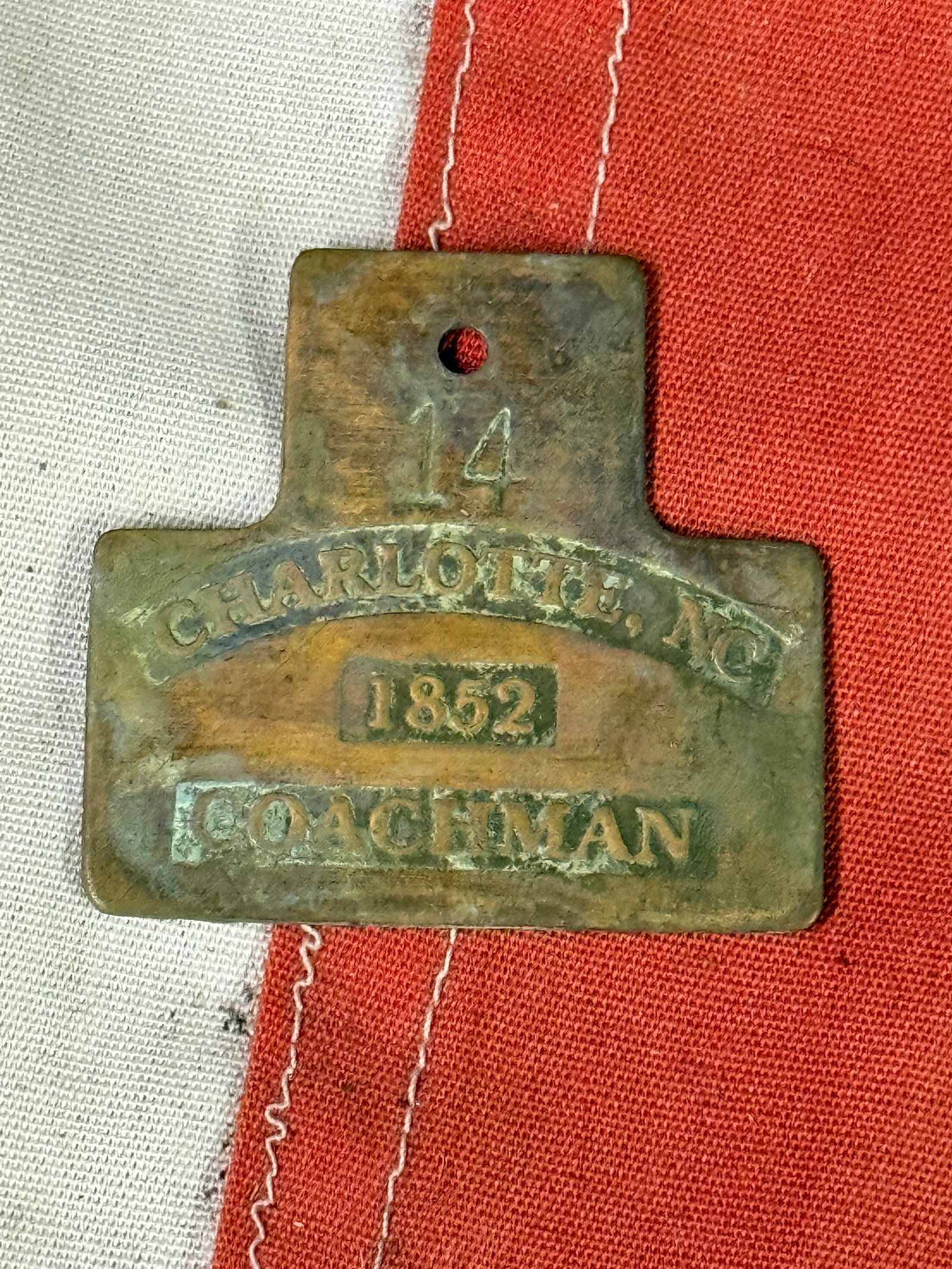 DATED 1852 CHARLOTTE, NC COACHMAN SLAVE TAG SERVANT ID #14: DATED 1852 CHARLOTTE, NC COACHMAN SLAVE TAG SERVANT ID #14. A VERY RARE FIND THAT IS IN MINT OVERALL SHAPE AND CONDITION WITH A BEAUTIFUL OVERALL PATINA. APPEARS TO BE WELL USED. PLEASE VIEW ALL DETAI