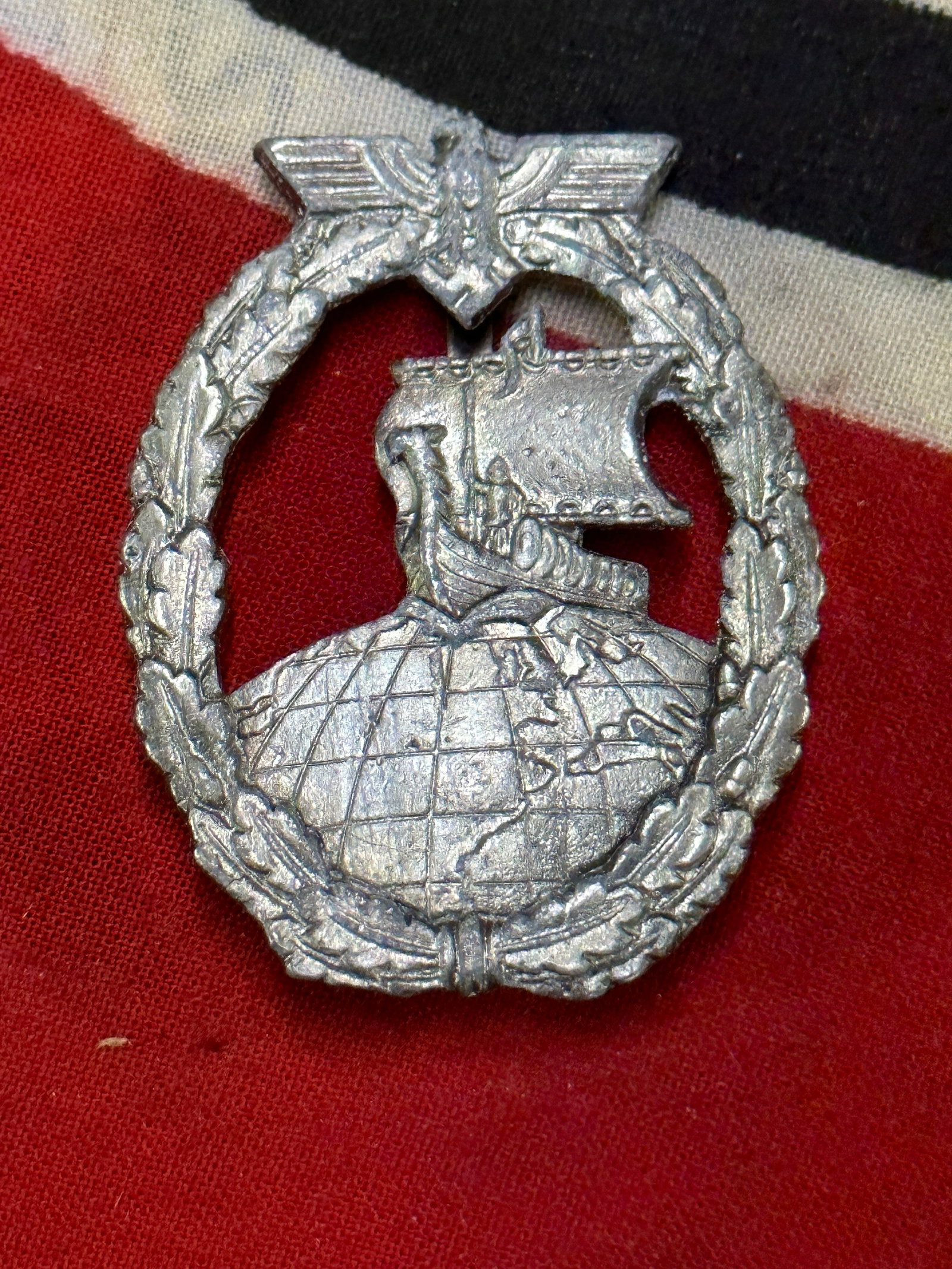 WW2 German Kriegsmarine auxiliary cruiser badge – Steinhauer & Luck: WW2 German Kriegsmarine auxiliary cruiser badge – Steinhauer & Luck. Kriegsmarine auxiliary cruiser badge – Steinhauer & Lück. Zink construction with riveted tombak globe. Typical later period S&