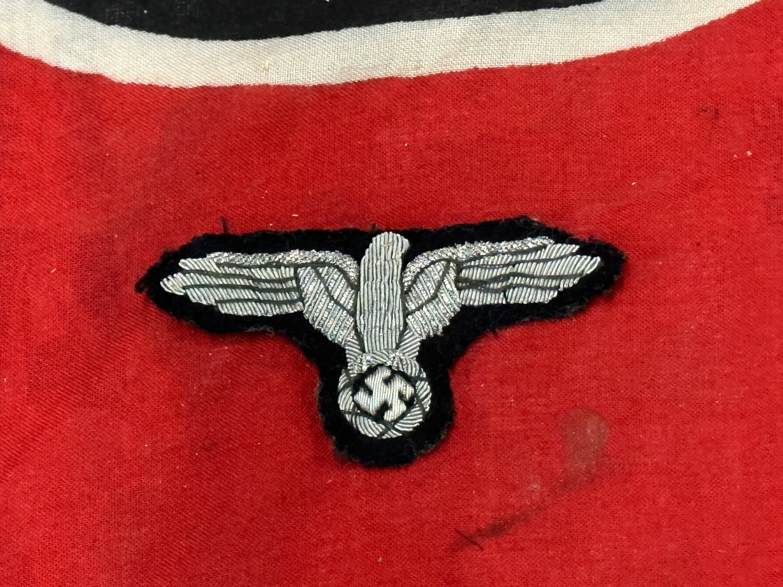 RARE WW2 GERMAN WAFFEN-SS SILVER BULLION ARM EAGLE INSIGNIA: RARE WW2 GERMAN WAFFEN-SS SILVER BULLION ARM EAGLE INSIGNIA. APPEARS TO BE WELL WORN WITH A BEAUTIFUL OVERALL PATINA. PLEASE VIEW ALL DETAILED PICTURES. A SCARCE EXAMPLE.