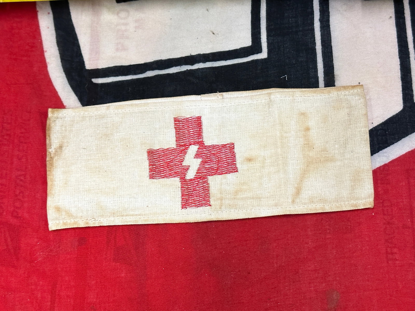 WW2 GERMAN WAFFEN SS RED CROSS CLOTH ARMBAND: WW2 GERMAN WAFFEN SS RED CROSS CLOTH ARMBAND. AN ULTRA RARE FIND THAT IS IN MINT OVERALL SHAPE AND CONDITION WITH A BEAUTIFUL OVERALL PATINA. SHOWS GOOD WEAR AND USE. A SCARCE EXAMPLE.