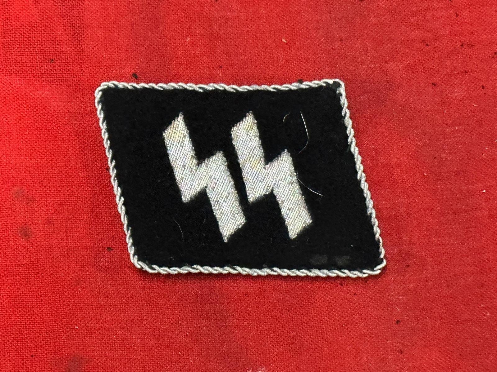 WW2 GERMAN SS EM/NCOs Runic Collar Tab: WW2 GERMAN SS EM/NCOs Runic Collar Tab. A scarce find. It is in mint overall shape and condition with a beautiful overall patina. Please view all detailed pictures. A scarce example.