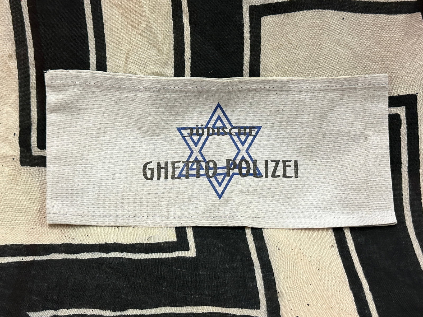 WW2 GERMAN JEWISH GHETTO POLIZEI ARMBAND IN CLOTH: WW2 GERMAN JEWISH GHETTO POLIZEI ARMBAND IN CLOTH. A RARE EXAMPLE THAT IS IN MINT OVERALL SHAPE AND CONDITION WITH A BEAUTIFUL OVERALL PATINA. PLEASE VIEW ALL DETAILED PICTURES. A SCARCE EXAMPLE.
