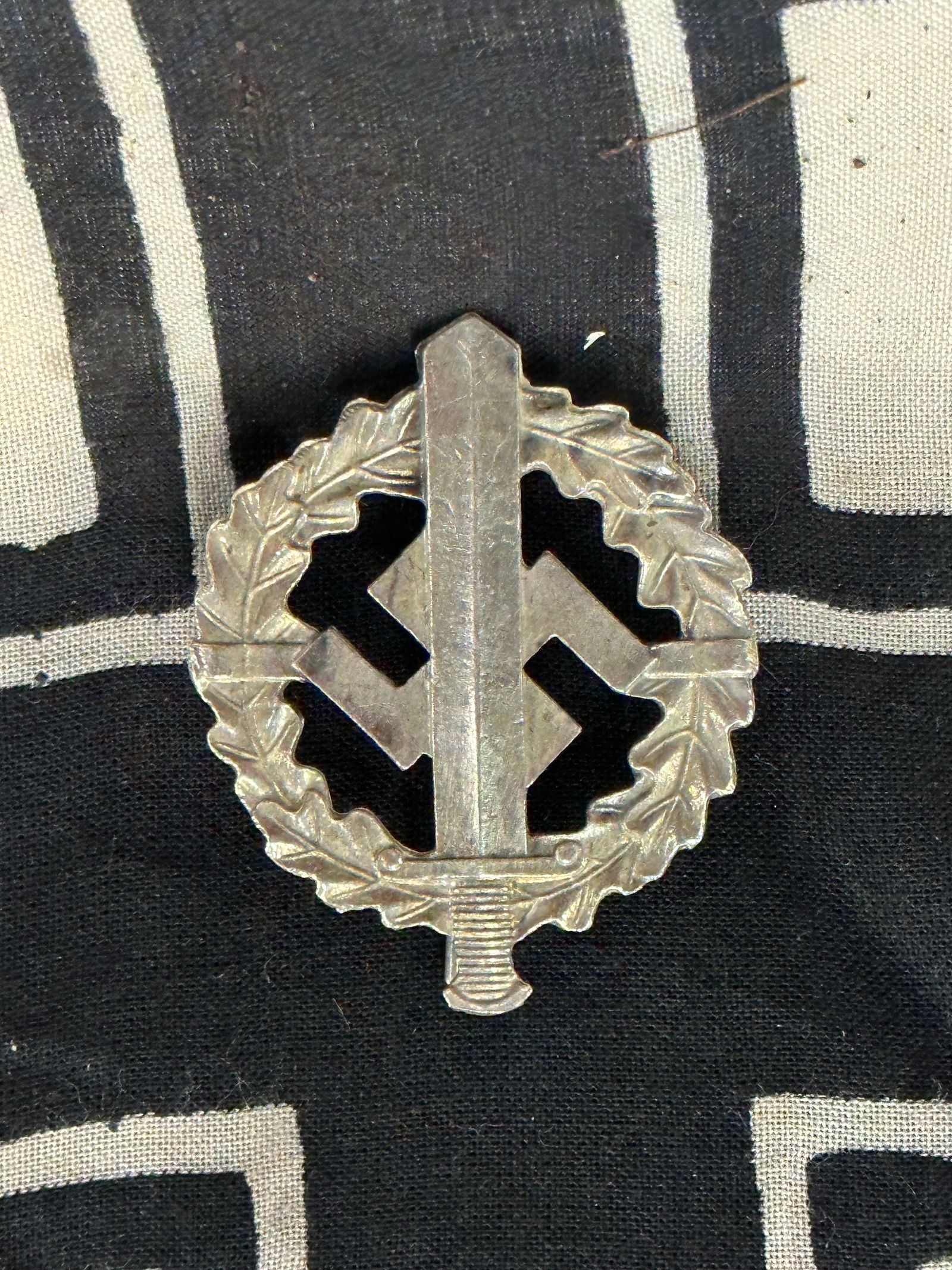 WW2 German SA Sports Badge in Silver by W. Redo: WW2 German SA Sports Badge in Silver by W. Redo. Minor oxidation but regardless as can be seen in the photos it looks remarkable on display. The SA Sports Badge was instituted on 28 November 1933 by t