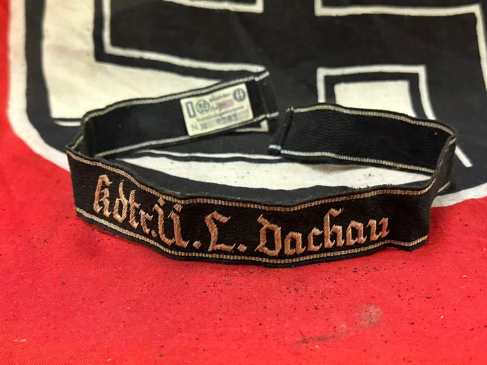 WW2 German Kdre.U.L.Dachau Brassard, Waffen SS Cuff Title With RZM Paper Tag: WW2 German Kdre.U.L.Dachau Brassard, Waffen SS Cuff Title With RZM Paper Tag. A very rare example that is in mint overall shape and condition with a beautiful overall patina. Shows good wear and use. 