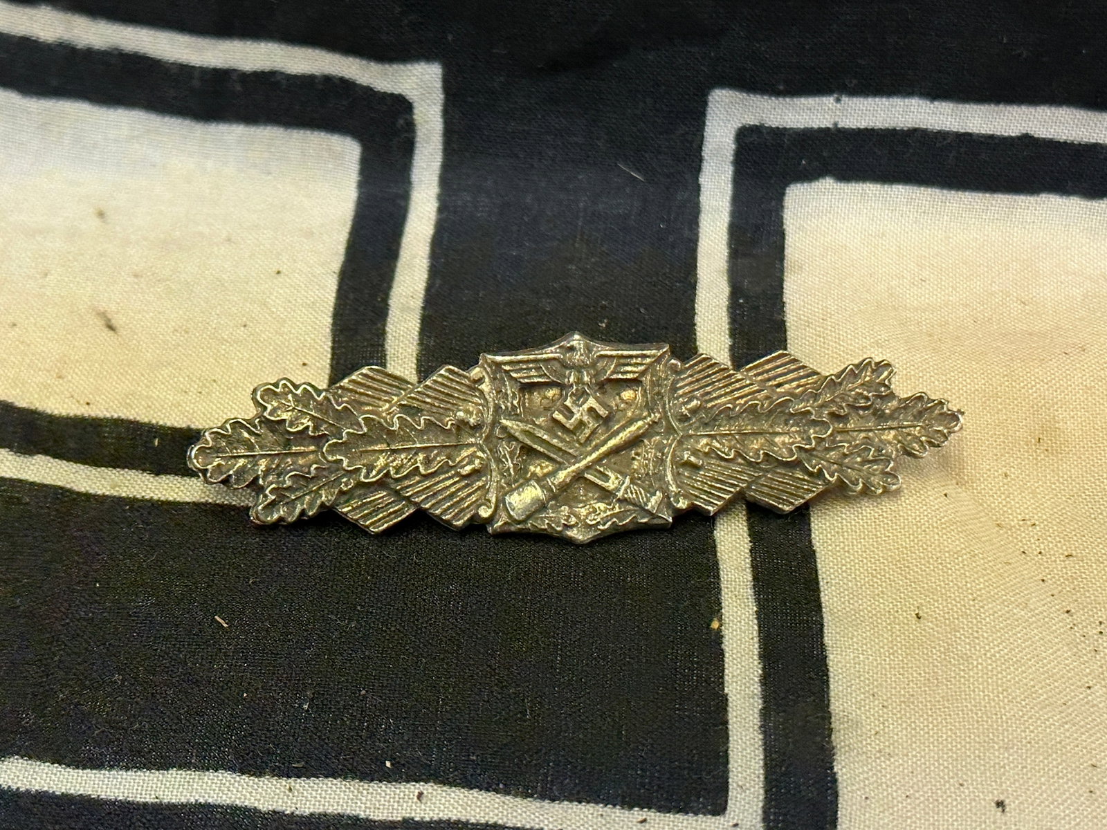 WW2 German Close Combat Clasp in Bronze By AGMuK: WW2 German Close Combat Clasp in Bronze By AGMuK. This Bronze Close Combat Clasp by AGMuK is a choice piece, in outstanding, near mint condition. It’s made of fine zinc, and retains nearly all of th