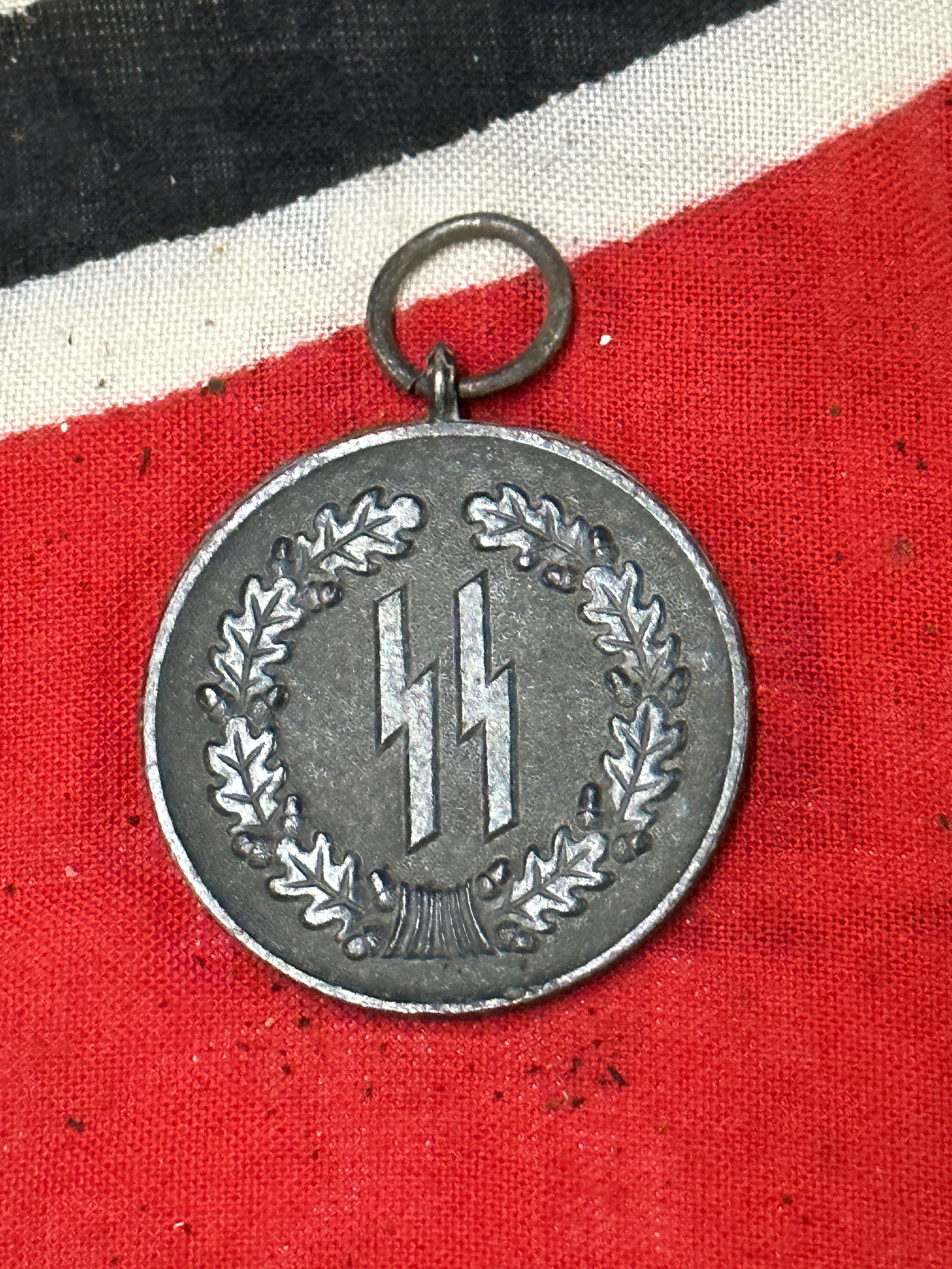 WW2 GERMAN WAFFEN SS SERVICE MEDAL FOR (4) YEAR SERVICE: WW2 GERMAN WAFFEN SS SERVICE MEDAL FOR (4) YEAR SERVICE. his SS Service Medal – 4 Year is a great, representative original example. The medal is struck from brass alloy (Tombak) with a blackened fin
