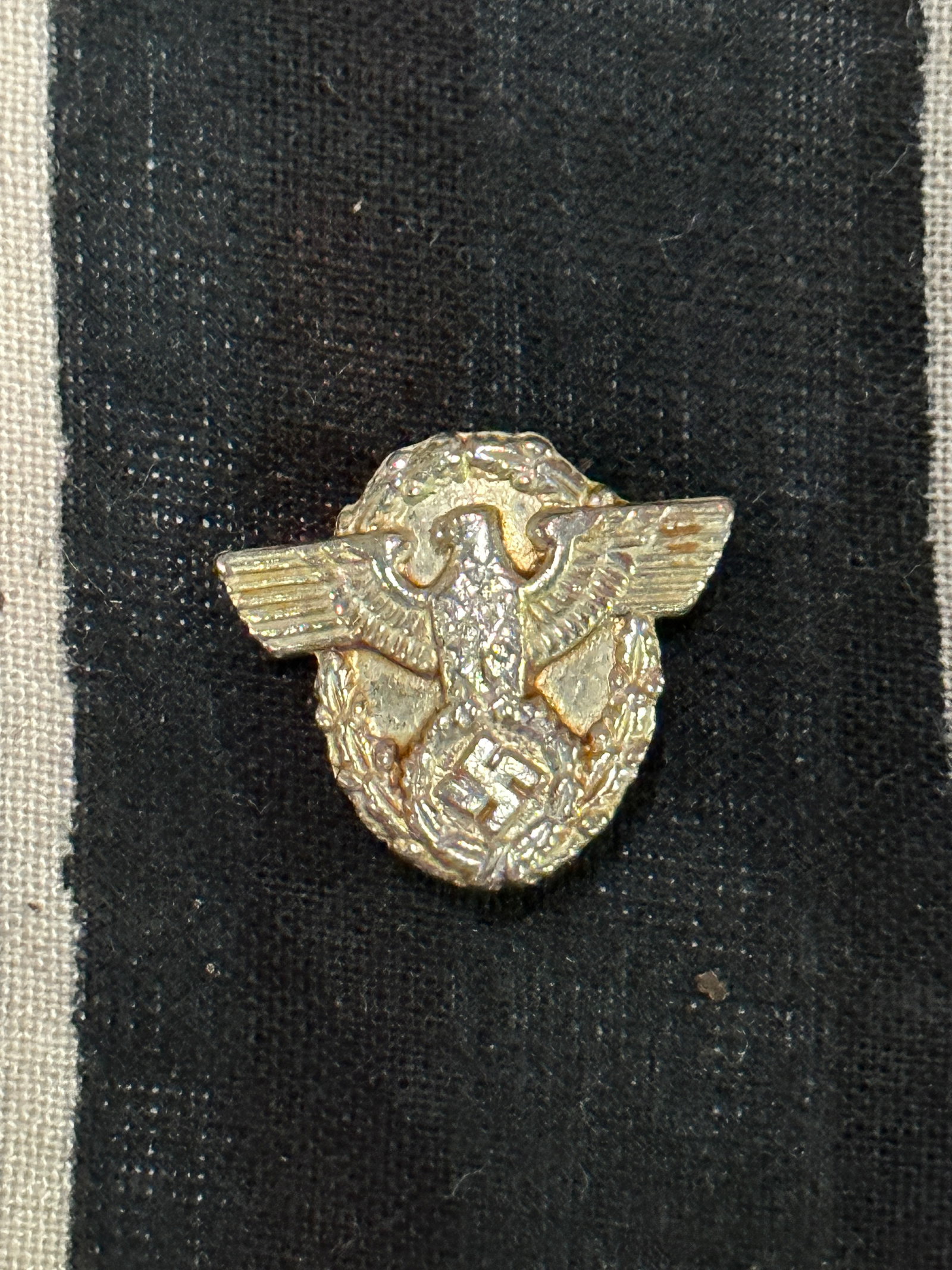RARE WW2 GERMAN POLICE NCO/EM VISOR HAT EAGLE BADGE BY RZM: RARE WW2 GERMAN POLICE NCO/EM VISOR HAT EAGLE BADGE BY RZM. Insignia is made of silver stamped aluminum with two brass prongs on the back and marked with maker "RZM". Used with light wear and age.