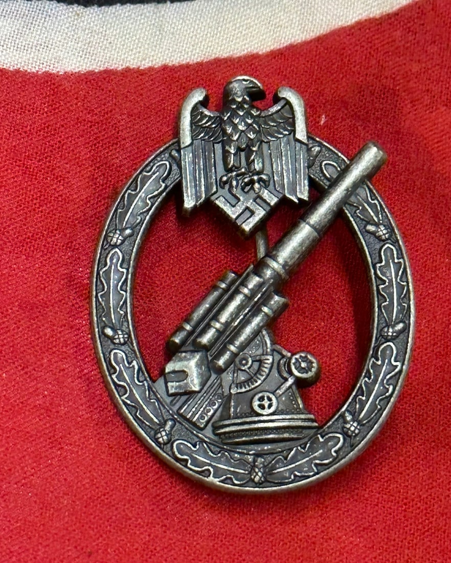 RARE WW2 GERMAN ARMY FLAK BADGE BY W.H.: RARE WW2 GERMAN ARMY FLAK BADGE BY W.H. A VERY RARE EXAMPLE THAT IS IN MINT OVERALL SHAPE AND CONDITION WITH A BEAUTIFUL OVERALL PATINA. SHOWS GOOD WEAR AND USE. PLEASE VIEW ALL DETAILED PICTURES. A S