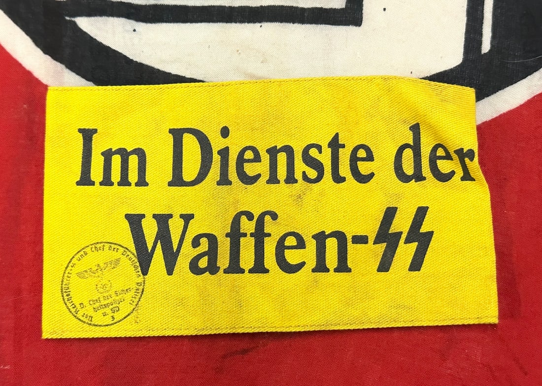 WW2 GERMAN IM DIENSTE DER WAFFEN-SS ARMBAND WITH INSPECTION STAMP: WW2 GERMAN IM DIENSTE DER WAFFEN-SS ARMBAND WITH INSPECTION STAMP. A RARE FIND. SHOWS GOOD WEAR AND USE WITH A BEAUTIFUL OVERALL PATINA. PLEASE VIEW ALL DETAILED PICTURES. A SCARCE EXAMPLE.