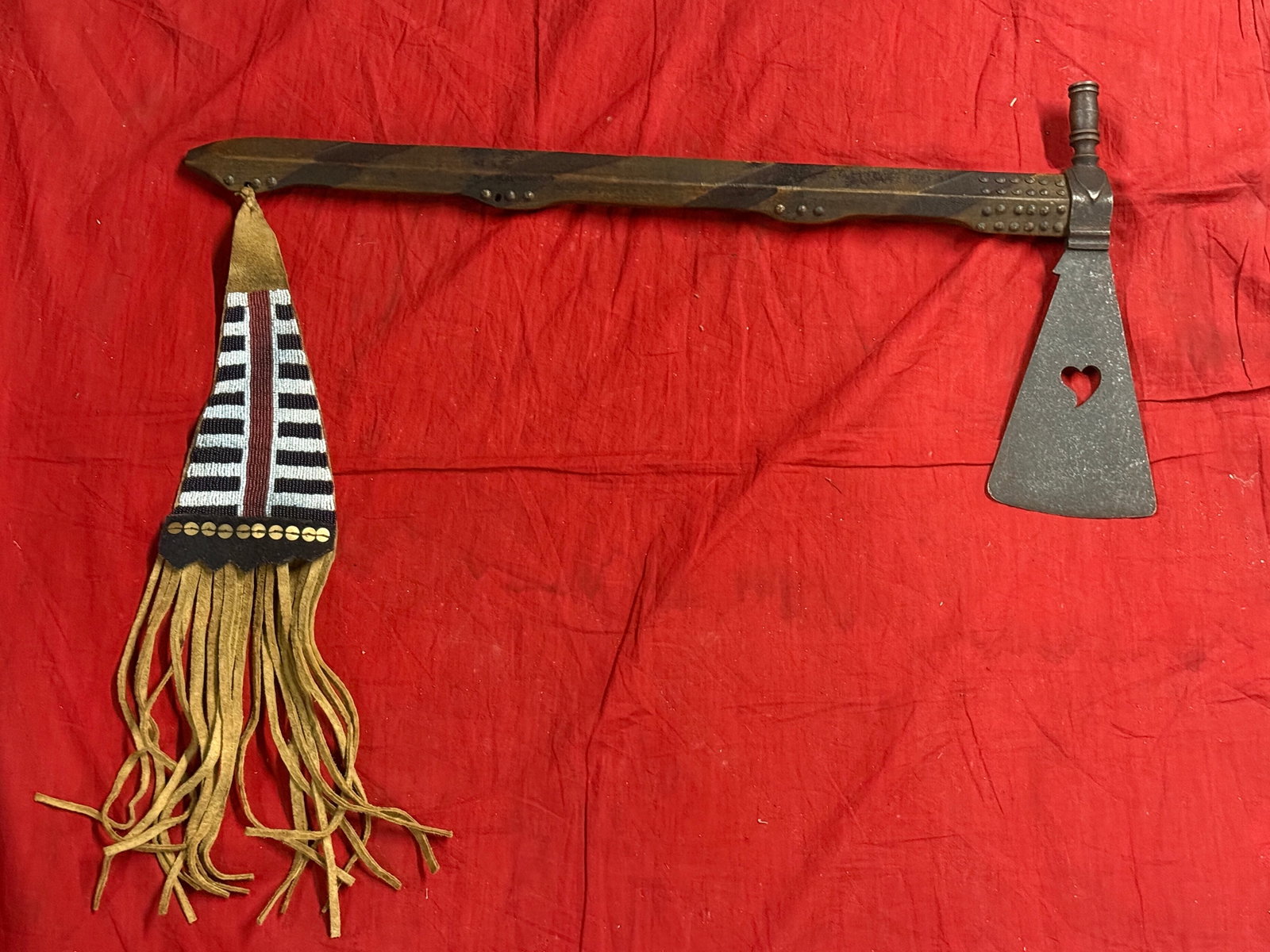 1800'S NATIVE AMERICAN FIGHTING SMOKE PIPE STUDDED AXE WITH BEADED DROP: 1800'S NATIVE AMERICAN FIGHTING SMOKE PIPE STUDDED AXE WITH BEADED DROP. THIS IS AN ULTRA RARE FIND THAT IS IN MINT OVERALL SHAPE AND CONDITION WITH A BEAUTIFUL OVERALL PATINA. HAS A GREAT LOOK TO IT 