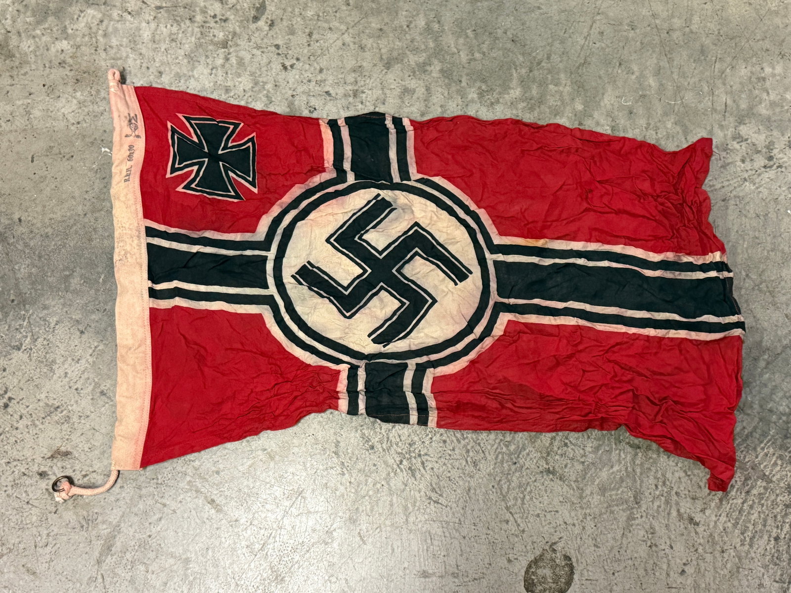 WW2 GERMAN KRIEGSMARINE NAVAL FLAG BY R.Kr.FL. 60x90: WW2 GERMAN KRIEGSMARINE NAVAL FLAG BY R.Kr.FL. 60x90. A VERY RARE FIND THAT IS IN MINT OVERALL SHAPE AND CONDITION WITH A BEAUTIFUL OVERALL PATINA. SHOWS GOOD WEAR AND USE AND IT IS MAKER MARKED. PLEA