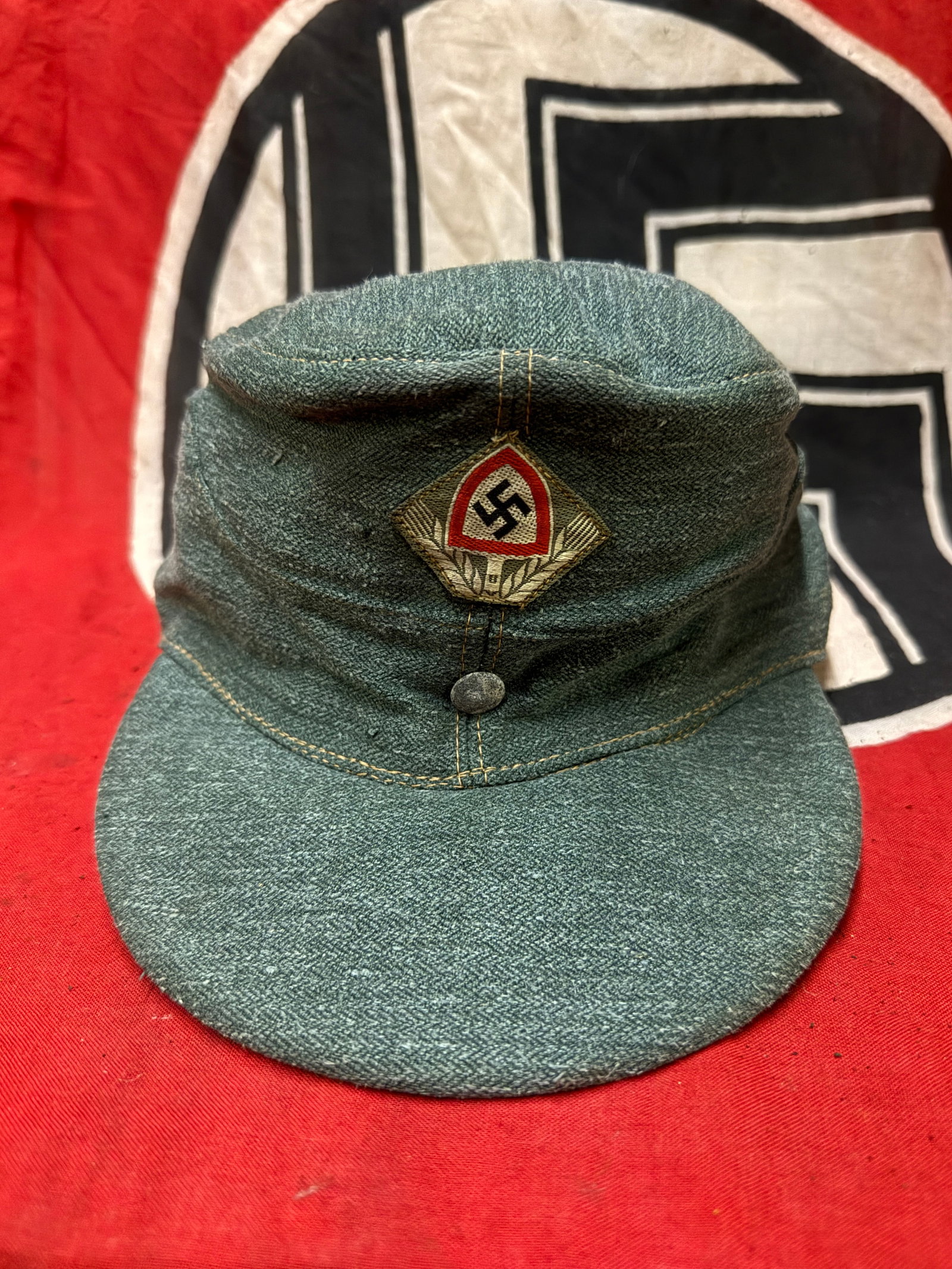 AUTHENTIC WW2 GERMAN REICHSARBEITSDIENST EM BILLED SERVICE CAP IN DRILLICH MATERIAL: AUTHENTIC WW2 GERMAN REICHSARBEITSDIENST EM BILLED SERVICE CAP IN DRILLICH MATERIAL. Reichsarbeitsdienst EM billed service cap in drillich material, with ribbed cotton liner, stamped in black ink with