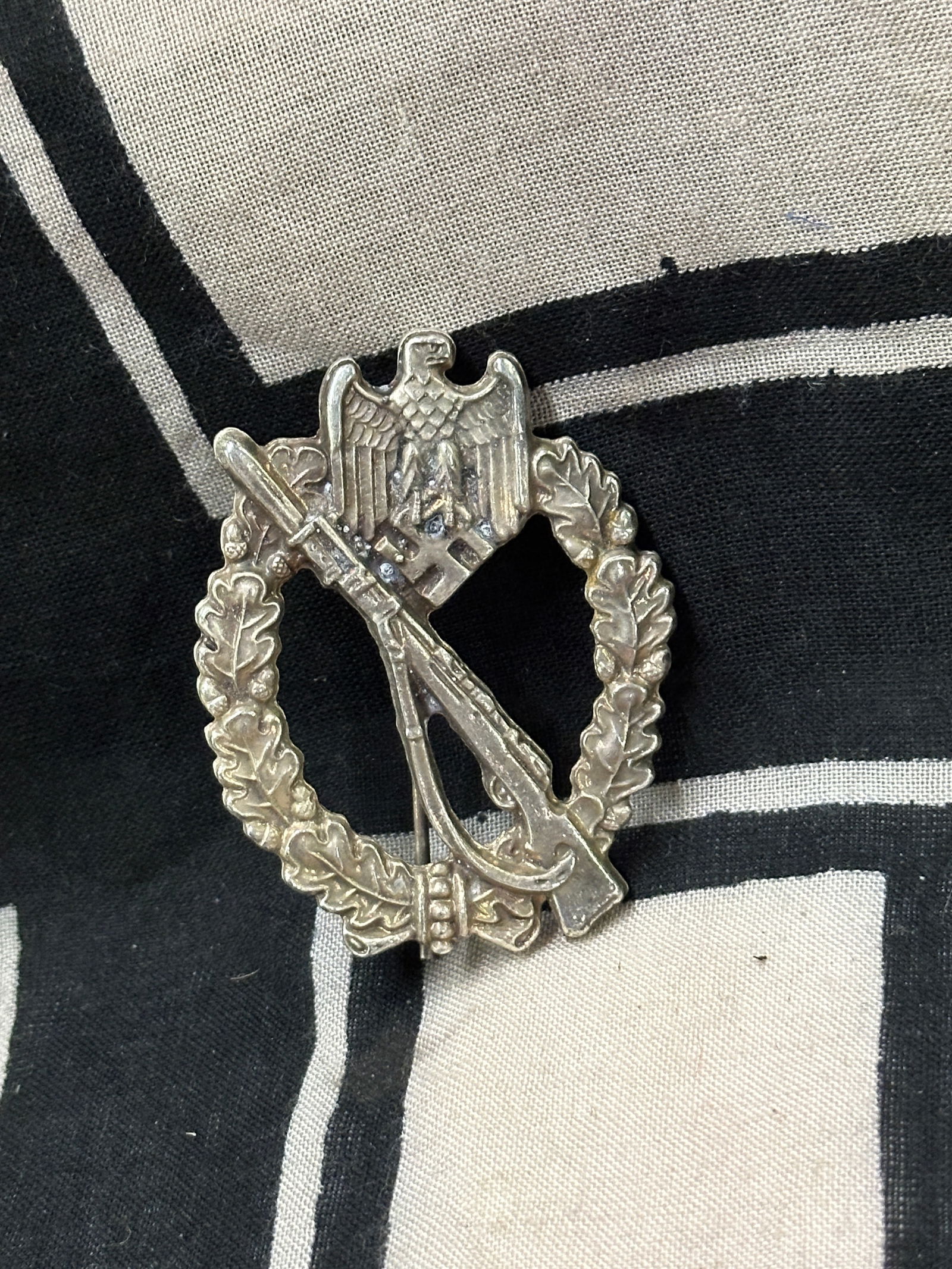 WW2 GERMAN INFANTRY ASSAULT BADGE IN SILVER BY RZM 01/23: WW2 GERMAN INFANTRY ASSAULT BADGE IN SILVER BY RZM 01/23. A VERY RARE FIND. SHOWS GOOD WEAR AND USE WITH A BEAUTIFUL OVERALL PATINA. PLEASE VIEW ALL DETAILED PICTURES. A VERY RARE EXAMPLE.