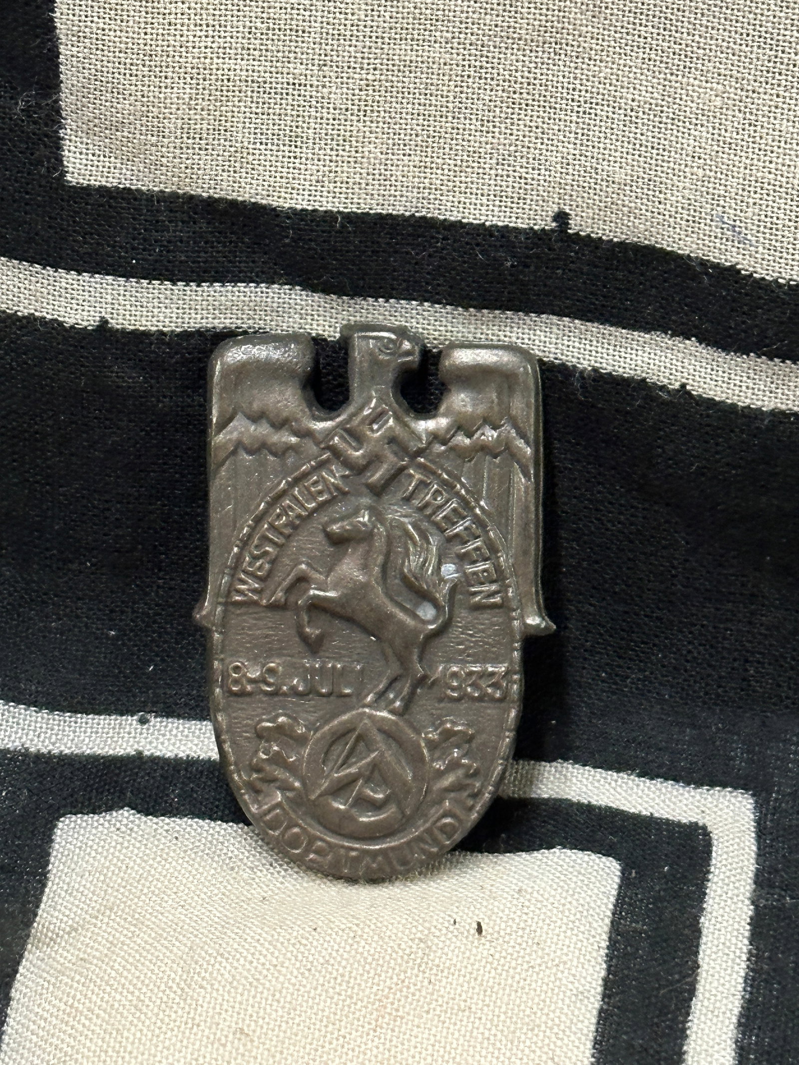 WW2 GERMAN 1933 SA DORTMUND-WESTFALEN MEETING BADGE: WW2 GERMAN 1933 SA DORTMUND-WESTFALEN MEETING BADGE. A VERY RARE FIND. SHOWS GOOD WEAR AND USE WITH A BEAUTIFUL OVERALL PATINA. PLEASE VIEW ALL DETAILED PICTURES. A RARE EXAMPLE.
