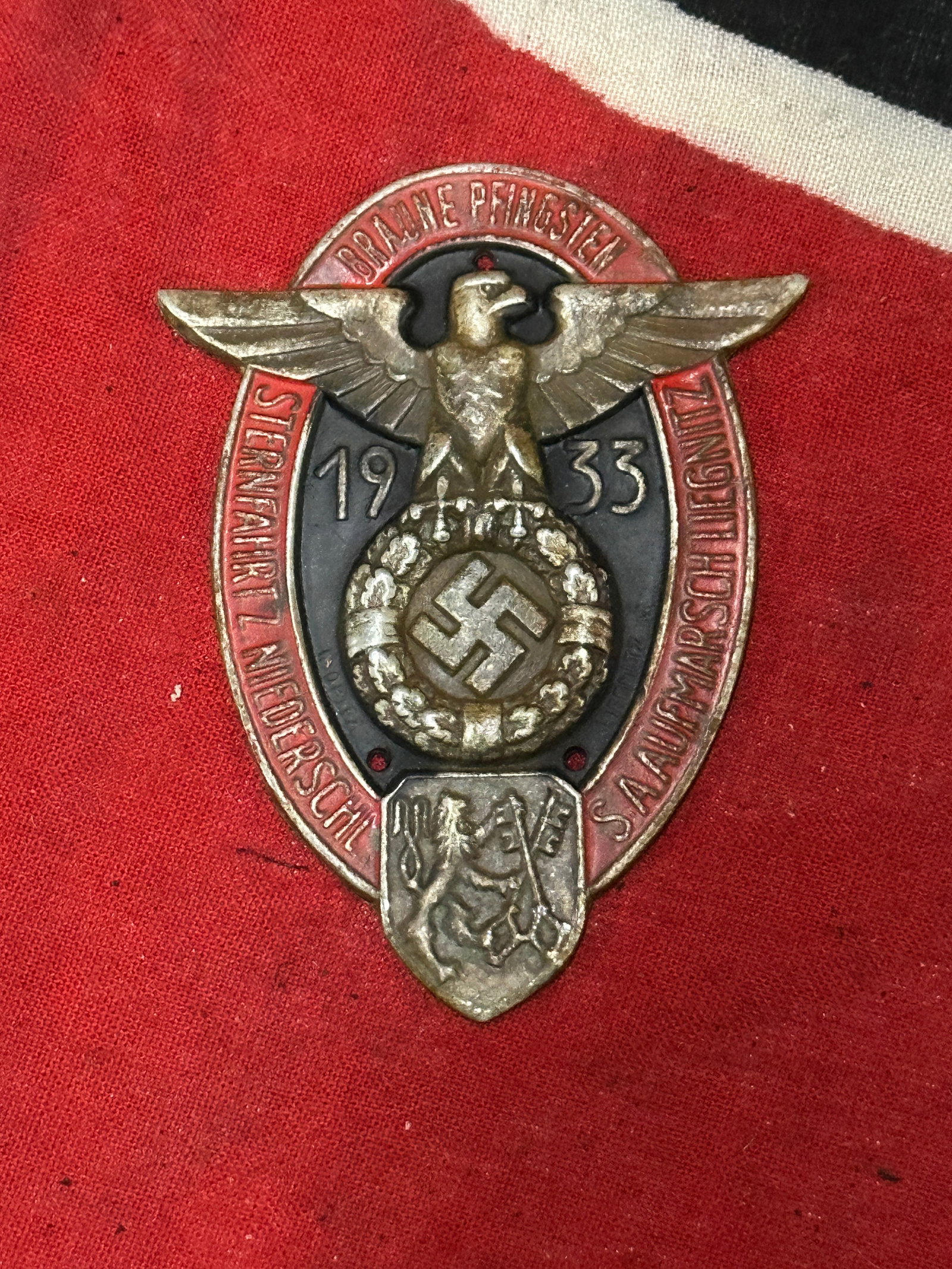 GERMAN WWII 1933 POLITICAL BRAUNE PFINGSTEN BADGE: GERMAN WWII 1933 POLITICAL BRAUNE PFINGSTEN BADGE. A RARE EXAMPLE THAT IS IN MINT OVERALL SHAPE AND CONDITION WITH A BEAUTIFUL OVERALL PATINA. SHOWS GOOD WEAR AND USE. A VERY SCARCE EXAMPLE.