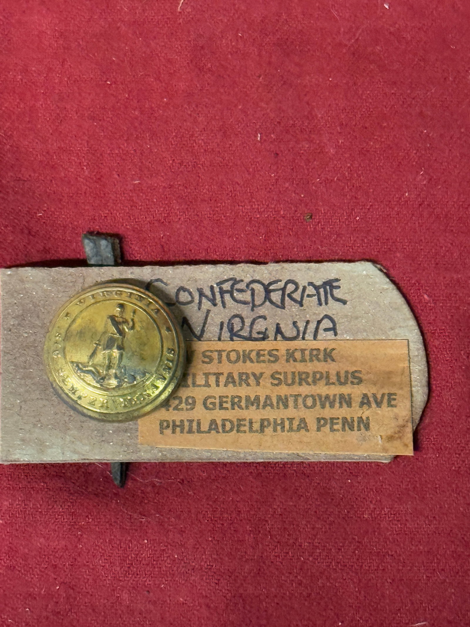 CIVIL WAR CONFEDERATE CSA VIRGINIA REBEL BUTTON BY W. STOKES KIRK: CIVIL WAR CONFEDERATE CSA VIRGINIA REBEL BUTTON BY W. STOKES KIRK. A RARE COAT BUTTON THAT IS IN MINT OVERALL SHAPE AND CONDITION WITH A BEAUTIFUL OVERALL PATINA. COMES ATTACHED TO THE MAKER MARK TAG.