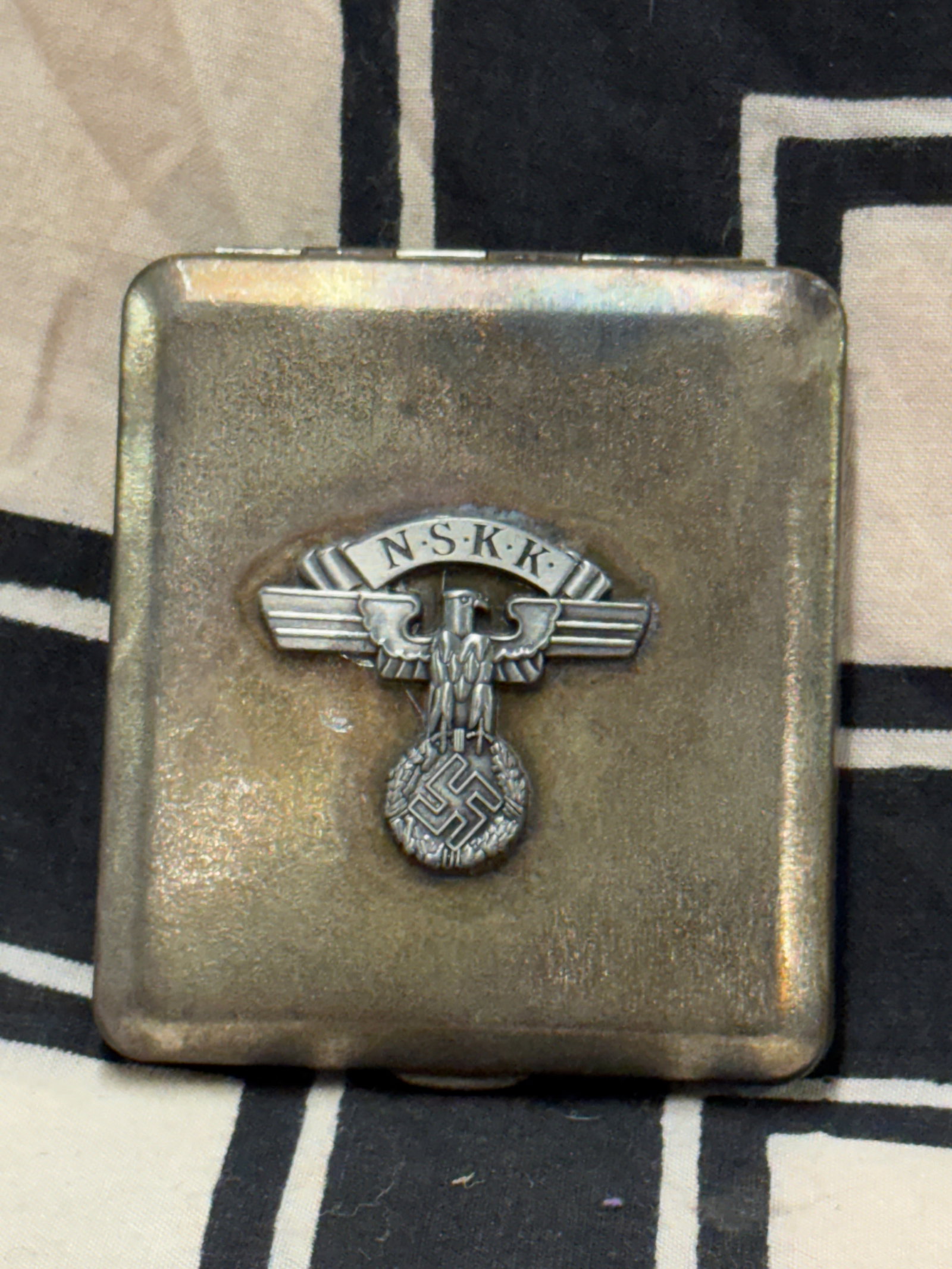 RARE WW2 GERMAN NSKK SOLDIER IN SERVICE CIGARETTE CASE: RARE WW2 GERMAN NSKK SOLDIER IN SERVICE CIGARETTE CASE. AN ULTRA RARE FIND. MAKER MARKED ON THE INSIDE. SHOWS GOOD WEAR AND USE WITH A BEAUTIFUL OVERALL PATINA. PLEASE VIEW ALL DETAILED PICTURES. A RA