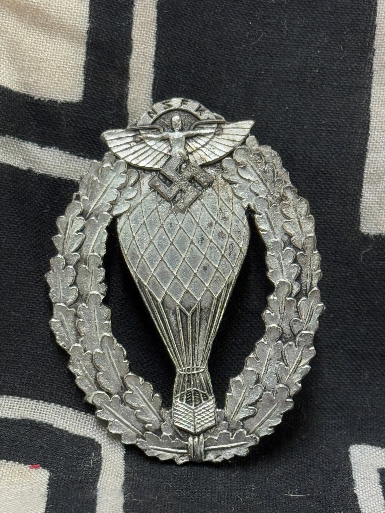 WWII GERMAN THIRD REICH NSFK BALLOON PILOT BADGE: WWII GERMAN THIRD REICH NSFK BALLOON PILOT BADGE. In excellent shape and condition with a beautiful overall patina. Shows good wear and use. Please view all detailed pictures. A scarce find.