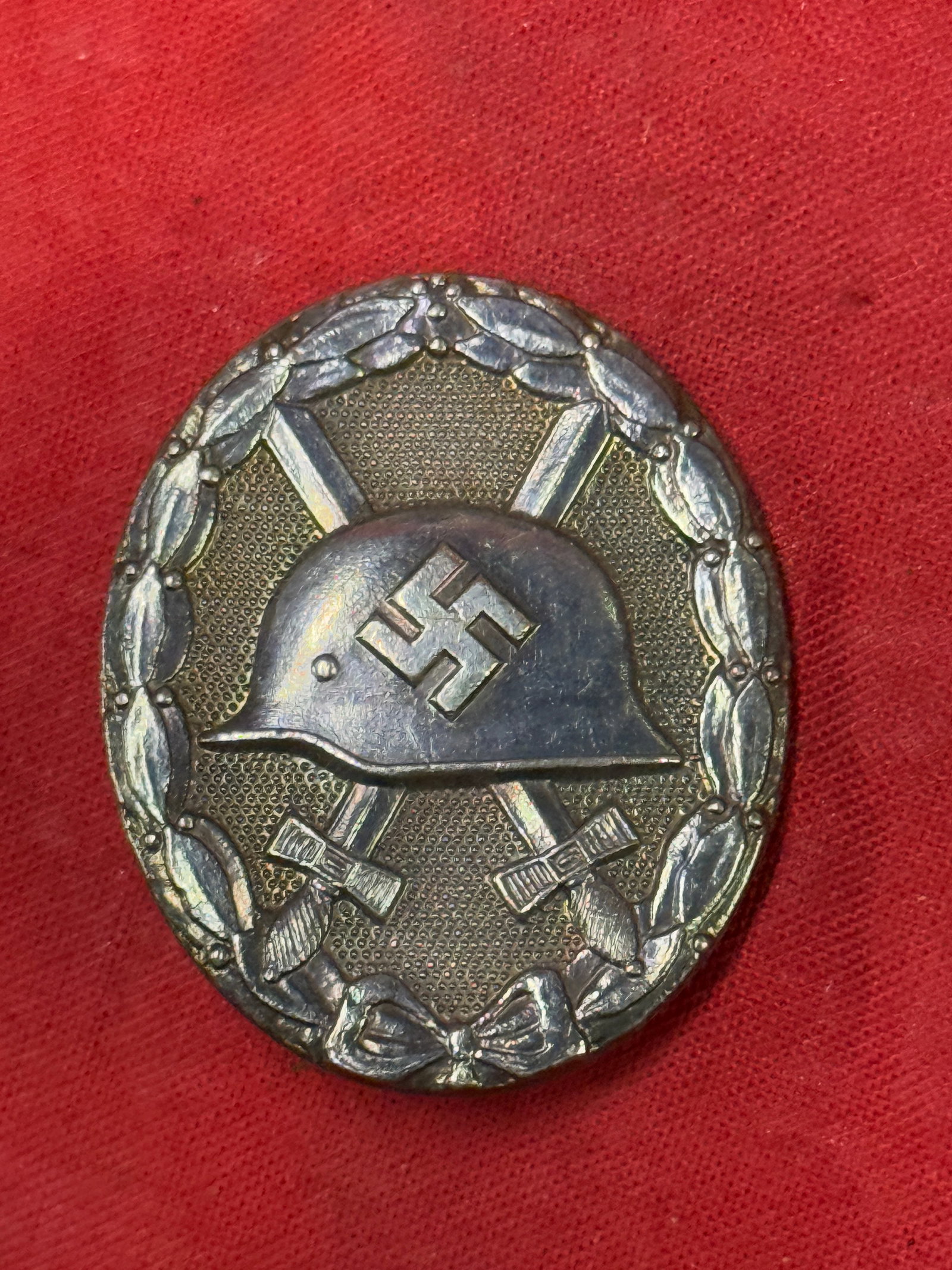 RARE WW2 GERMAN 1939 TOMBAK SILVER WOUND BADGE MARKED L/14: RARE WW2 GERMAN 1939 TOMBAK SILVER WOUND BADGE MARKED L/14. The silver badge is higher award than the black. The badge was instituted in three classes, of black, silver and gold with the class bestowe