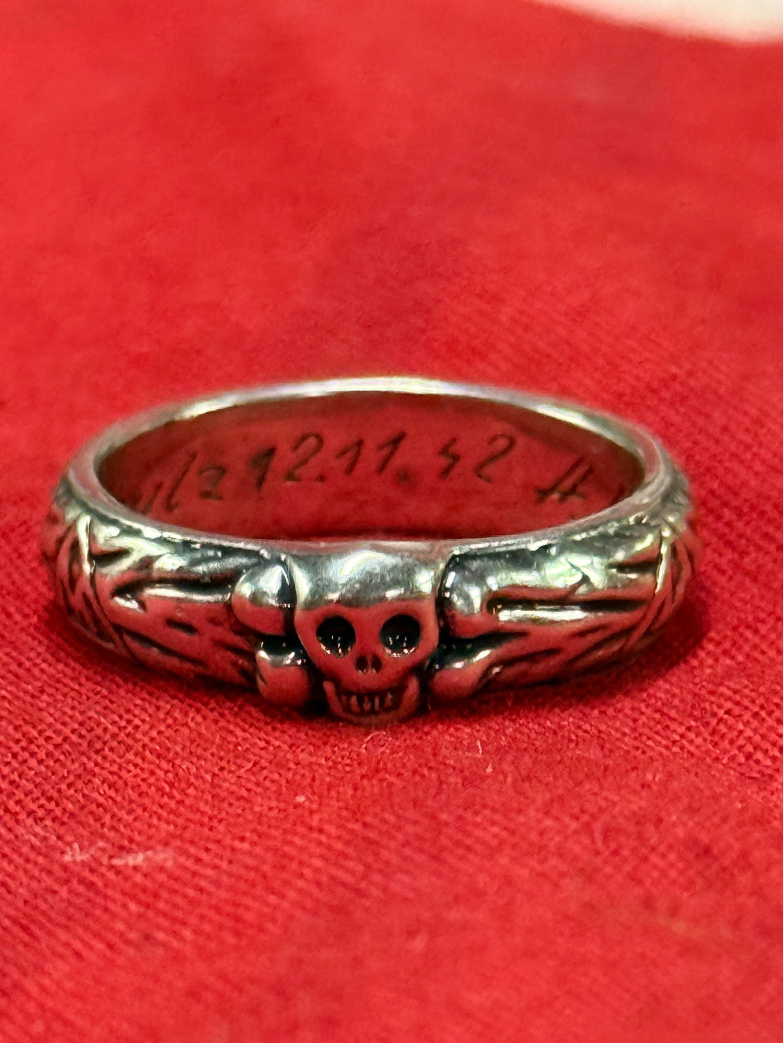 DATED 12/11/42 WW2 GERMAN TOTENKOPF SS SKULL SILVER OFFICER RING: DATED 12/11/42 WW2 GERMAN TOTENKOPF SS SKULL SILVER OFFICER RING. AN ULTRA RARE FIND THAT IS IN MINT OVERALL SHAPE AND CONDITION WITH A BEAUTIFUL OVERALL PATINA. SHOWS GOOD WEAR AND USE. PLEASE VIEW A