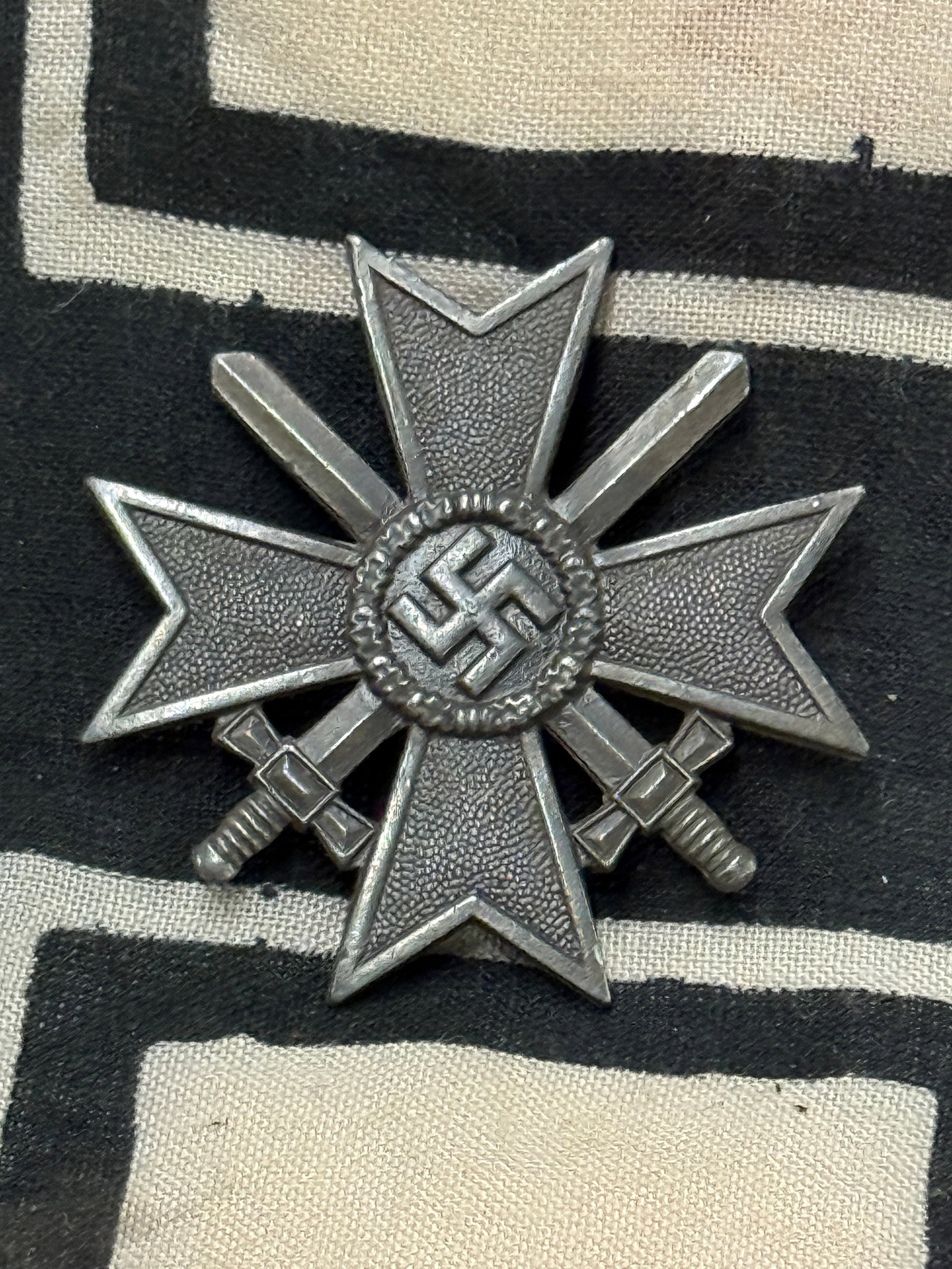 WW2 GERMAN WAR MERIT CROSS 1ST CLASS WITH SWORDS BADGE: WW2 GERMAN WAR MERIT CROSS 1ST CLASS WITH SWORDS BADGE. MISSING LATCH PIN ON THE REVERSE. SHOWS GOOD WEAR AND USE. A RARE EXAMPLE.