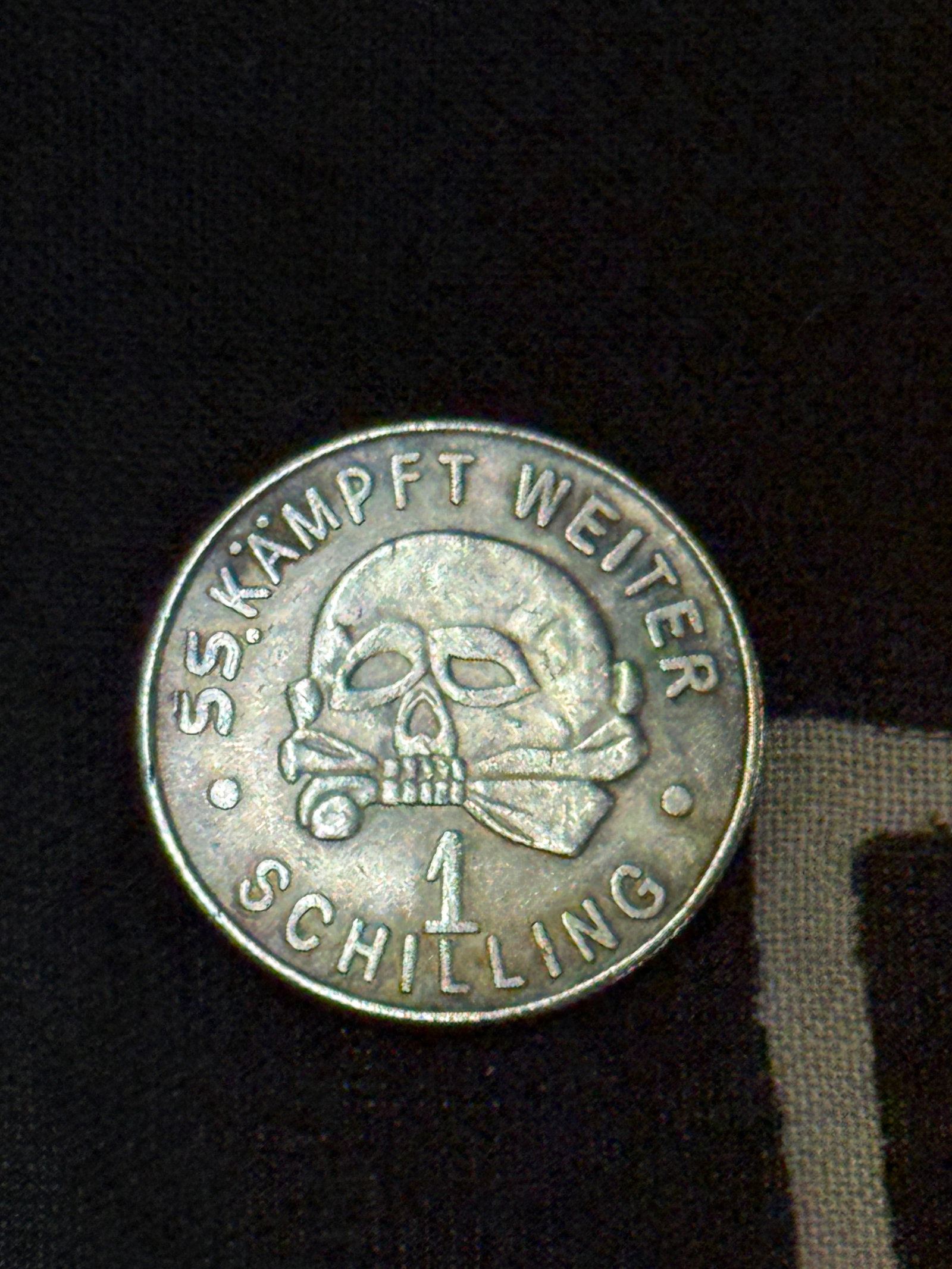 WW2 GERMAN SS KAMPFT WEITER 1 SCHILLING SS COIN 1940 KANTINEGELD: WW2 GERMAN SS KAMPFT WEITER 1 SCHILLING SS COIN 1940 KANTINEGELD. AN ULTRA RARE FIND THAT IS IN MINT OVERALL SHAPE AND CONDITION WITH A BEAUTIFUL OVERALL PATINA. SHOWS GOOD WEAR AND USE. A SCARCE EXAM