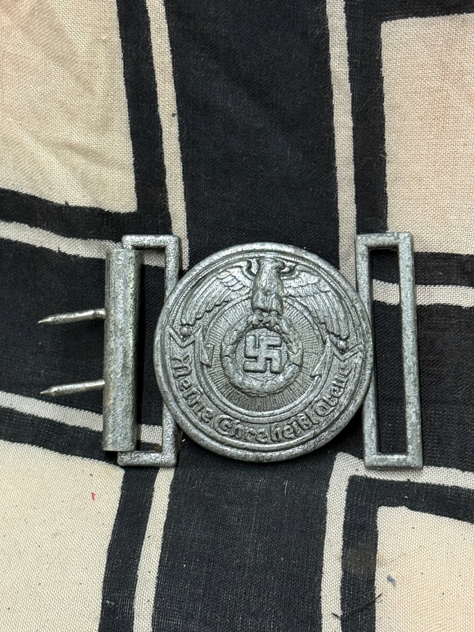 WW2 GERMAN WAFFEN-SS OFFICER BELT BUCKLE BY RZM: WW2 GERMAN WAFFEN-SS OFFICER BELT BUCKLE BY RZM. The obverse of the SS officer’s belt buckle depicts an eagle with outstrecched wings clutching a wreathed swastika in its talons, with a scroll below