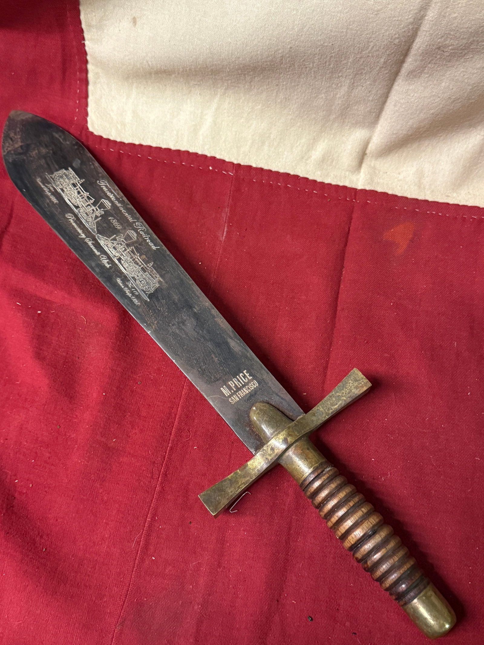 1869 TRANSCONTINENTAL RAILROAD OFFICER DAGGER BY M. PRICE SAN FRANCISCO: 1869 TRANSCONTINENTAL RAILROAD OFFICER DAGGER BY M. PRICE SAN FRANCISCO. A VERY NICE ENGRAVED BLADE WITH THE TRAIN MOTIF. SHOWS GOOD WEAR AND USE WITH A BEAUTIFUL OVERALL PATINA. HAS A BEAUTIFUL WOODE
