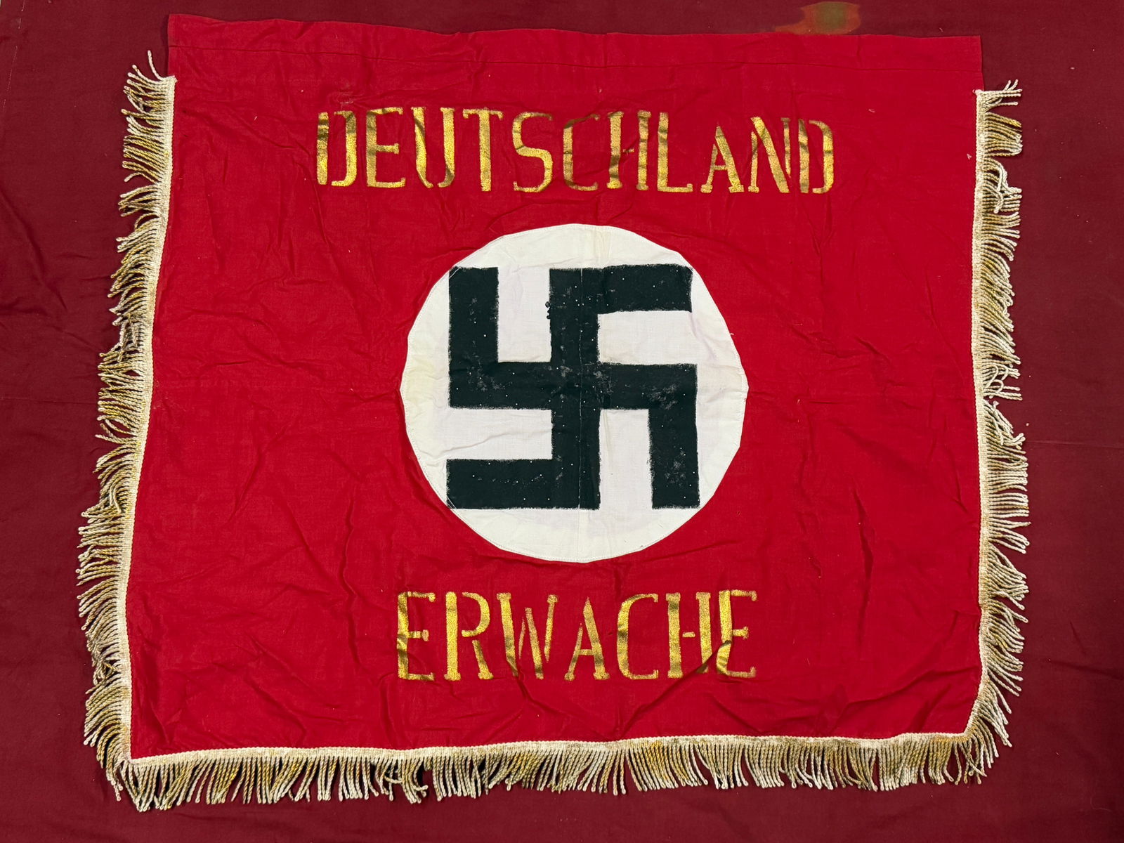 WW2 GERMAN DEUTSCHLAND ERWACHE STANDARD FLAG: WW2 GERMAN DEUTSCHLAND ERWACHE STANDARD FLAG. A VERY RARE FIND. SHOWS GOOD WEAR AND USE WITH A BEAUTIFUL OVERALL PATINA. This is probably one of the most recognized flags of the third Reich. Known by