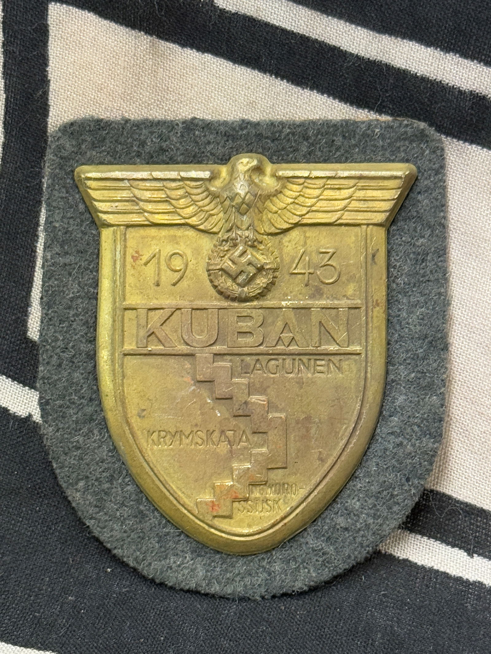 WW2 GERMAN KUBAN Shield on Army/Waffen-SS Backing: WW2 GERMAN KUBAN Shield on Army/Waffen-SS Backing. Shows good wear and use with a beautiful overall patina. Shows good wear and use. Appears to be well use. A rare example.