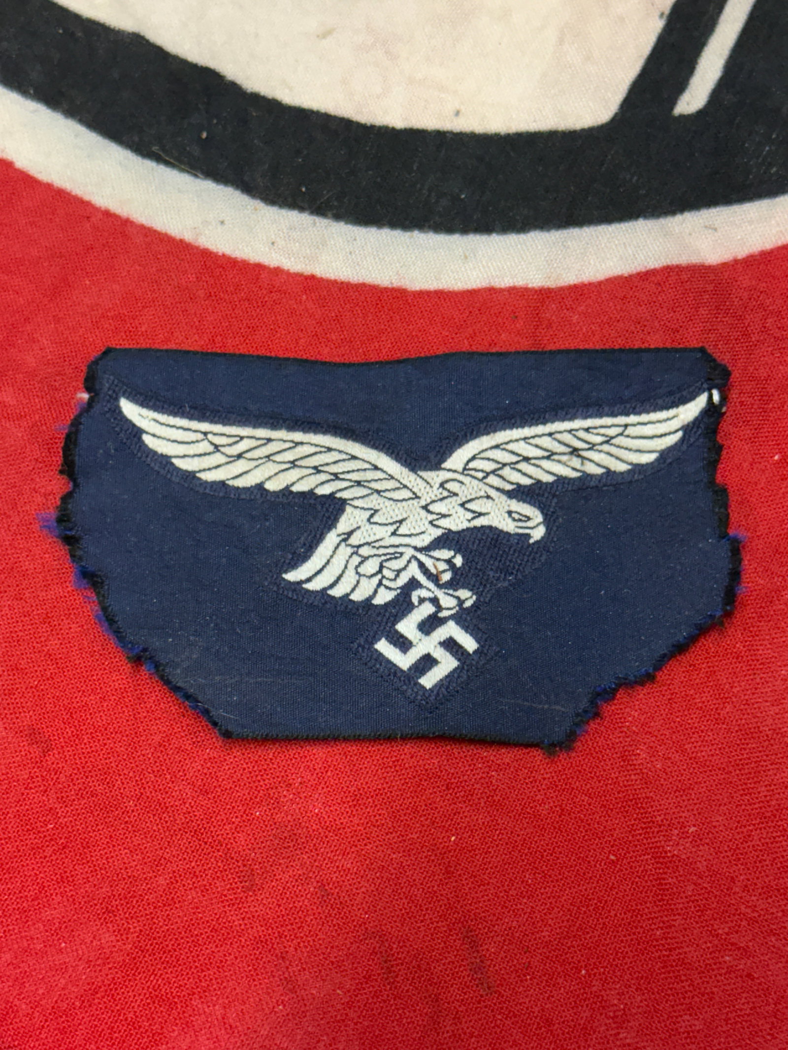 WW2 GERMAN ENLISTED MAN'S CLOTH EAGLE BADGE INSIGNIA: WW2 GERMAN ENLISTED MAN'S CLOTH EAGLE BADGE INSIGNIA. A RARE UN-ISSUED EXAMPLE THAT IS IN MINT OVERALL SHAPE AND CONDITION WITH A BEAUTIFUL OVERALL PATINA. SHOWS GOOD WEAR AND USE. A RARE EXAMPLE.