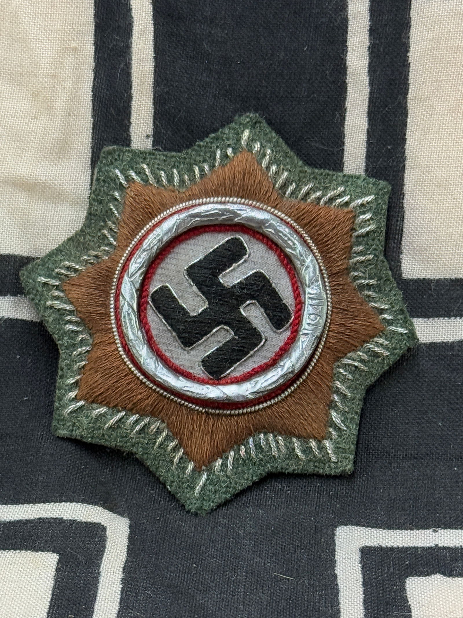 WW2 GERMAN CROSS IN GOLD CLOTH VERSION: WW2 GERMAN CROSS IN GOLD CLOTH VERSION. Multi piece construction with brass wreath and bullion wire. Type ‘1’ version unissued condition. Shows some light edge wear and moth eaten bit at one side,