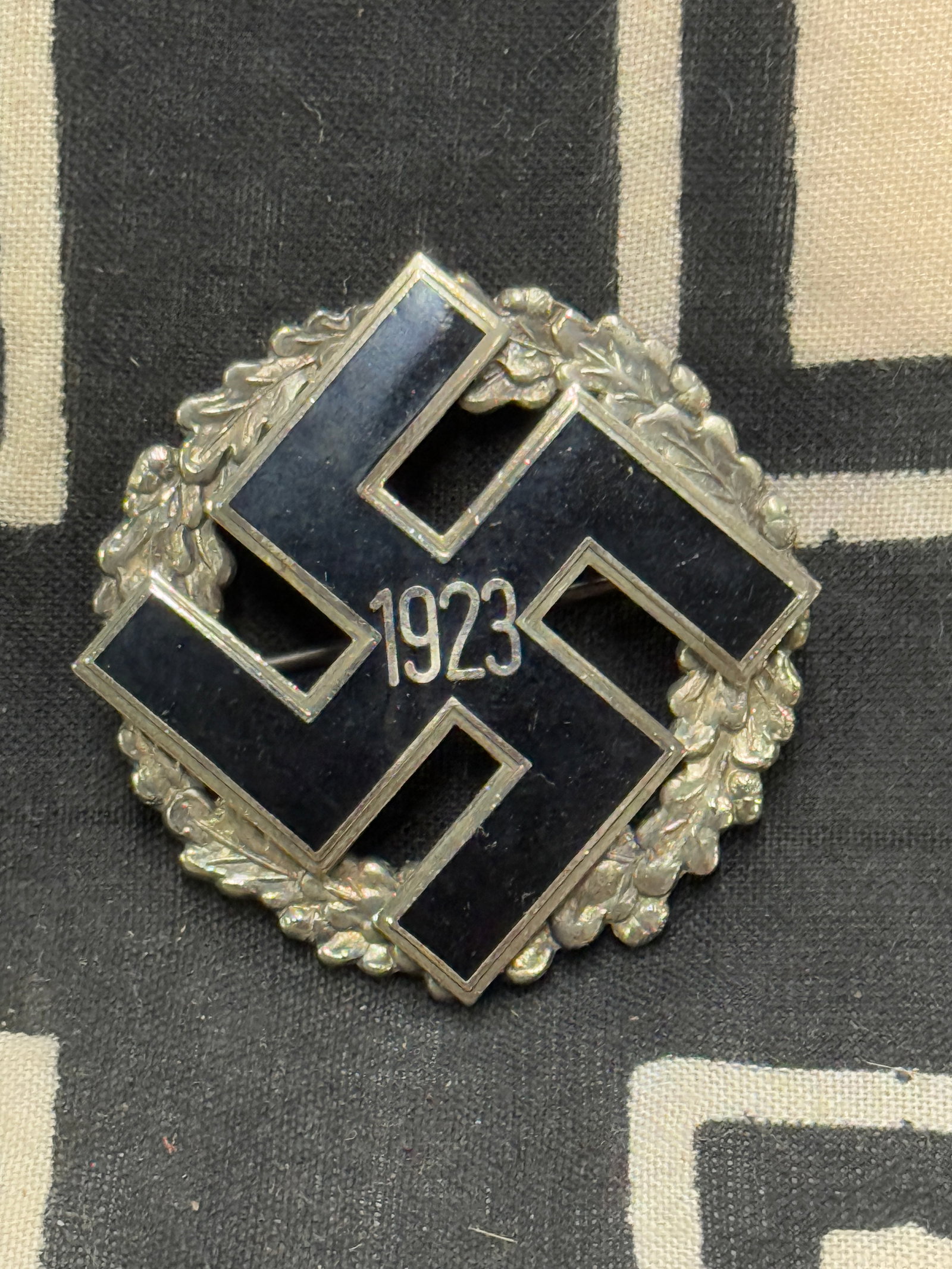 WWII GERMAN NSDAP GENERAL HONOR GAU BADGE 1923: WWII GERMAN NSDAP GENERAL HONOR GAU BADGE 1923. Nickel construction with enamel swastika. Horizontal pin back with C-hook closure. Very good condition.