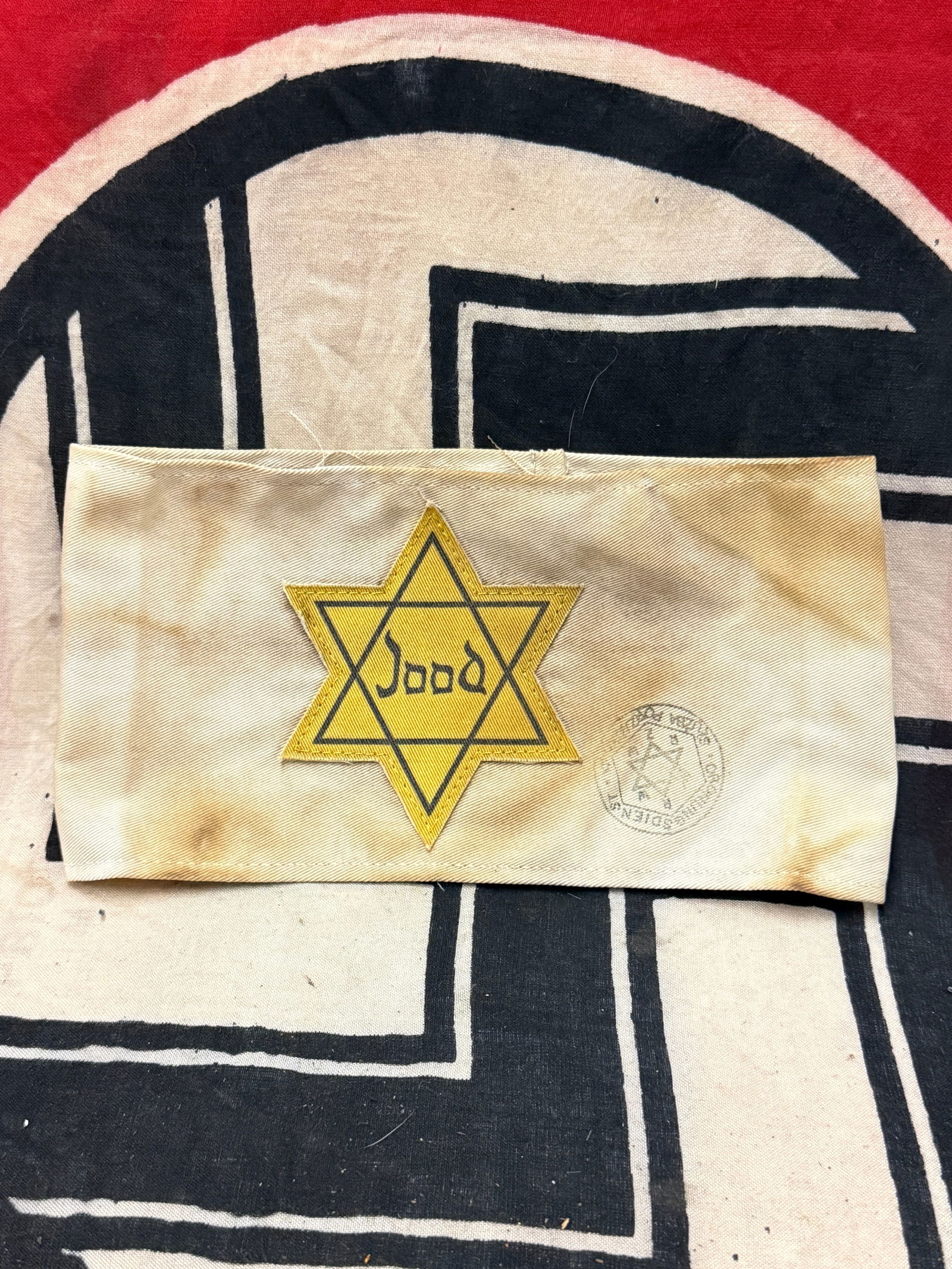 WW2 GERMAN JOOD CONCENTRATION CAMP STAR OF DAVID ARMBAND WITH INSPECTION STAMP: WW2 GERMAN JOOD CONCENTRATION CAMP STAR OF DAVID ARMBAND WITH INSPECTION STAMP. AN ULTRA RARE FIND. SHOWS GOOD WEAR AND USE WITH AN EVEN PATINA THROUGHOUT. PLEASE VIEW ALL DETAILED PICTURES. A VERY RA