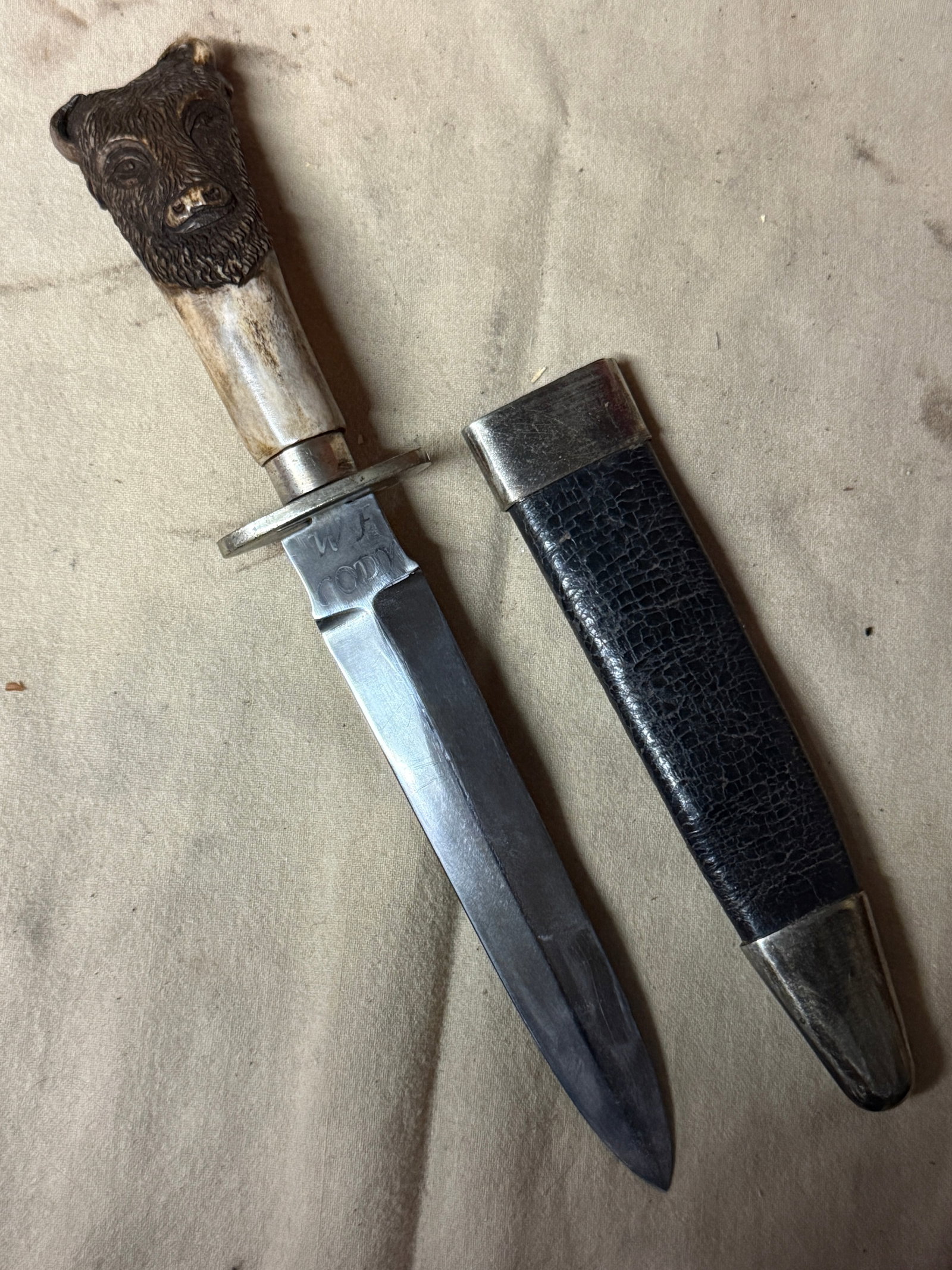 1800'S "BUFFALO BILL" W.F. CODY ID'D CARVED BUFFALO HANDLE BOWIE KNIFE BY TILLOTSOM, COLUMBIA PLACE,: 1800'S "BUFFALO BILL" W.F. CODY ID'D CARVED BUFFALO HANDLE BOWIE KNIFE BY TILLOTSOM, COLUMBIA PLACE, SHEFFIELD. COMES WITH THE ORIGINAL LEATHER SCABBARD. VERY WELL USED AND OWNED BY THE FAMOUS BUFFALO