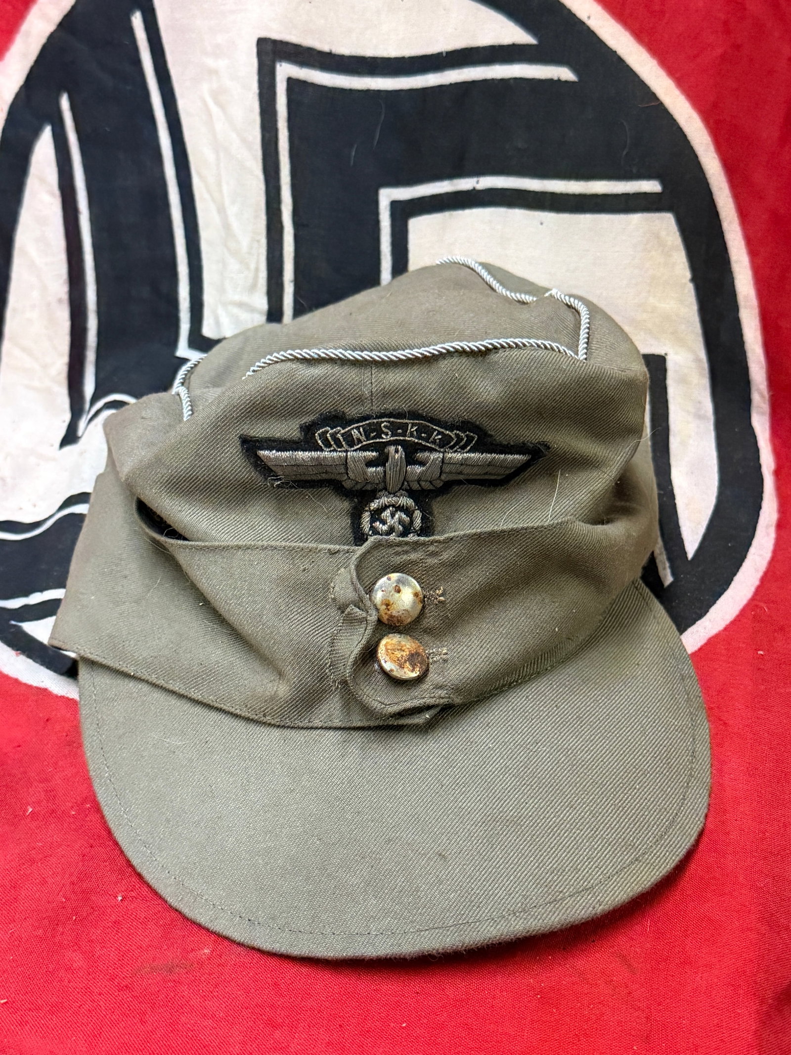 German WWII M43 NSKK National Socialist Motor Corps Officers Feldmütze Field Cap: German WWII M43 NSKK National Socialist Motor Corps Officers Feldmütze Field Cap. Very similar to the Heer Army version, it is constructed of wool gabardine cloth, with fold-down panels with squared 