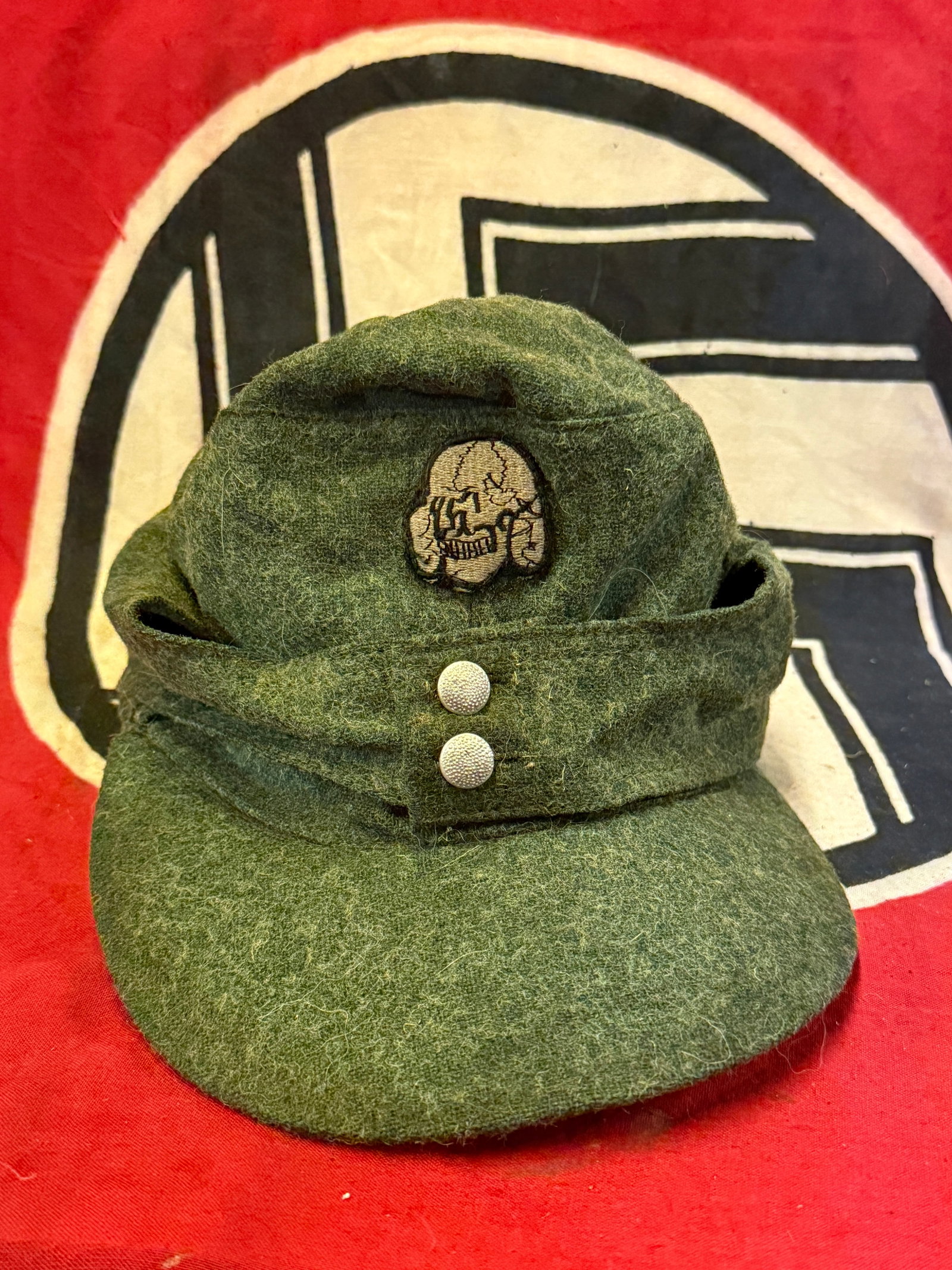 WW2 GERMAN WAFFEN SS TOTENKOPF EM/NCO M44 FIELDGRAY CAP WITH MAKER MARKS: WW2 GERMAN WAFFEN SS TOTENKOPF EM/NCO M44 FIELDGRAY CAP WITH MAKER MARKS. AN ULTRA RARE FIND THAT IS IN MINT OVERALL SHAPE AND CONDITION WITH A BEAUTIFUL OVERALL PATINA. SHOWS GOOD WEAR AND EVEN USE T