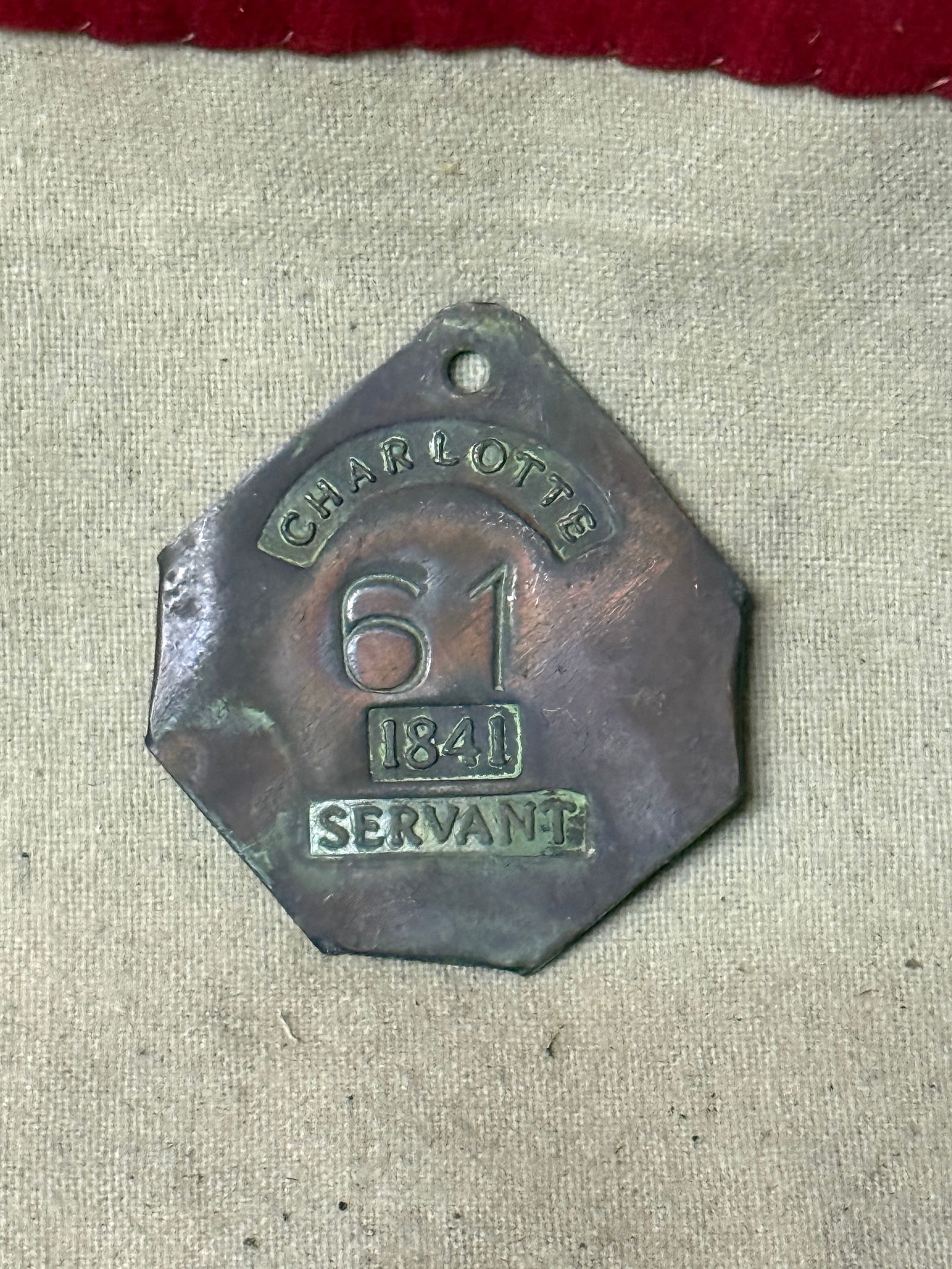 DATED 1841 CHARLOTTE #61 SLAVE TAG SERVANT ID: DATED 1841 CHARLOTTE #61 SLAVE TAG SERVANT ID. AN ULTRA RARE FIND THAT IS IN MINT OVERALL SHAPE AND CONDITION WITH A BEAUTIFUL OVERALL PATINA. SHOWS GOOD WEAR AND USE. PLEASE VIEW ALL DETAILED PICTURE