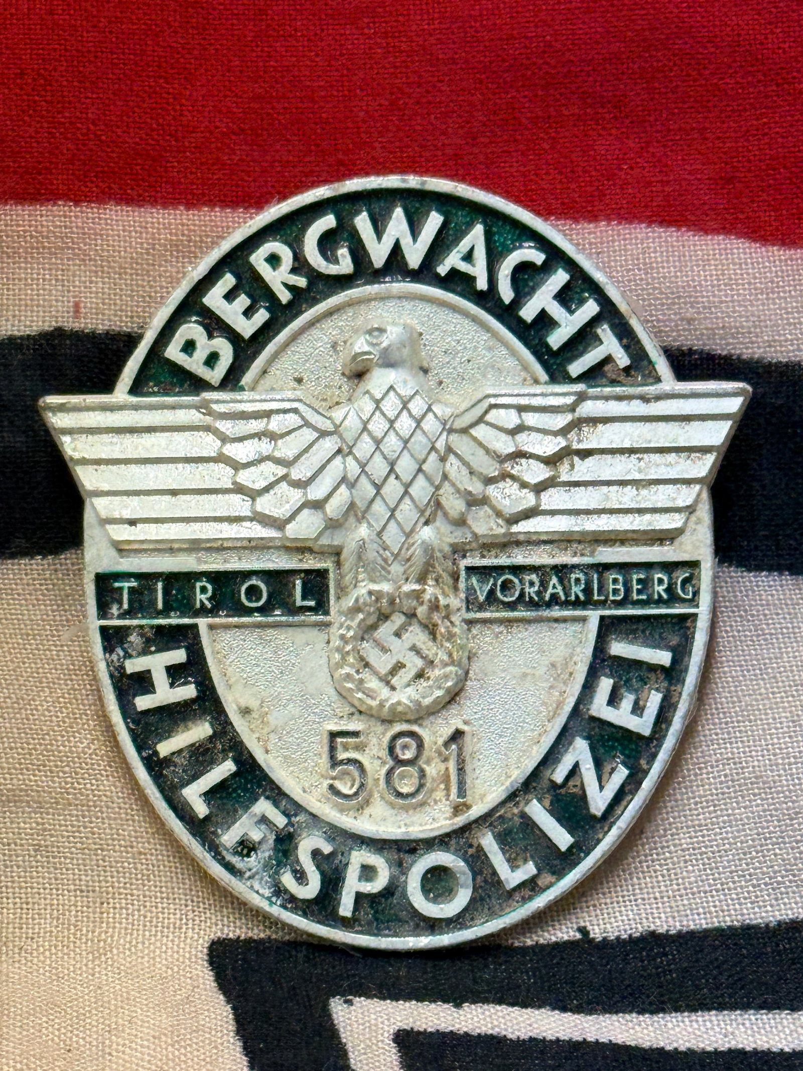 German WWII type Auxiliary Police badge numbered 581: German WWII type Auxiliary Police badge numbered 581. An ultra rare example that is in mint overall shape and condition with a beautiful overall patina. Shows good wear and use. Please view all detail